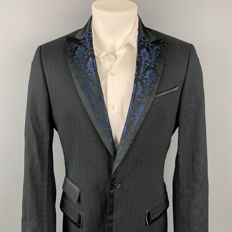 JUST CAVALLI sport coat comes in a black stripe material with a full print liner featuring a blue print peak lapel, flap pockets, and a single button closure.

Very Good Pre-Owned Condition.
Marked: 52

Measurements:

Shoulder: 17.5 in.
Chest: 42