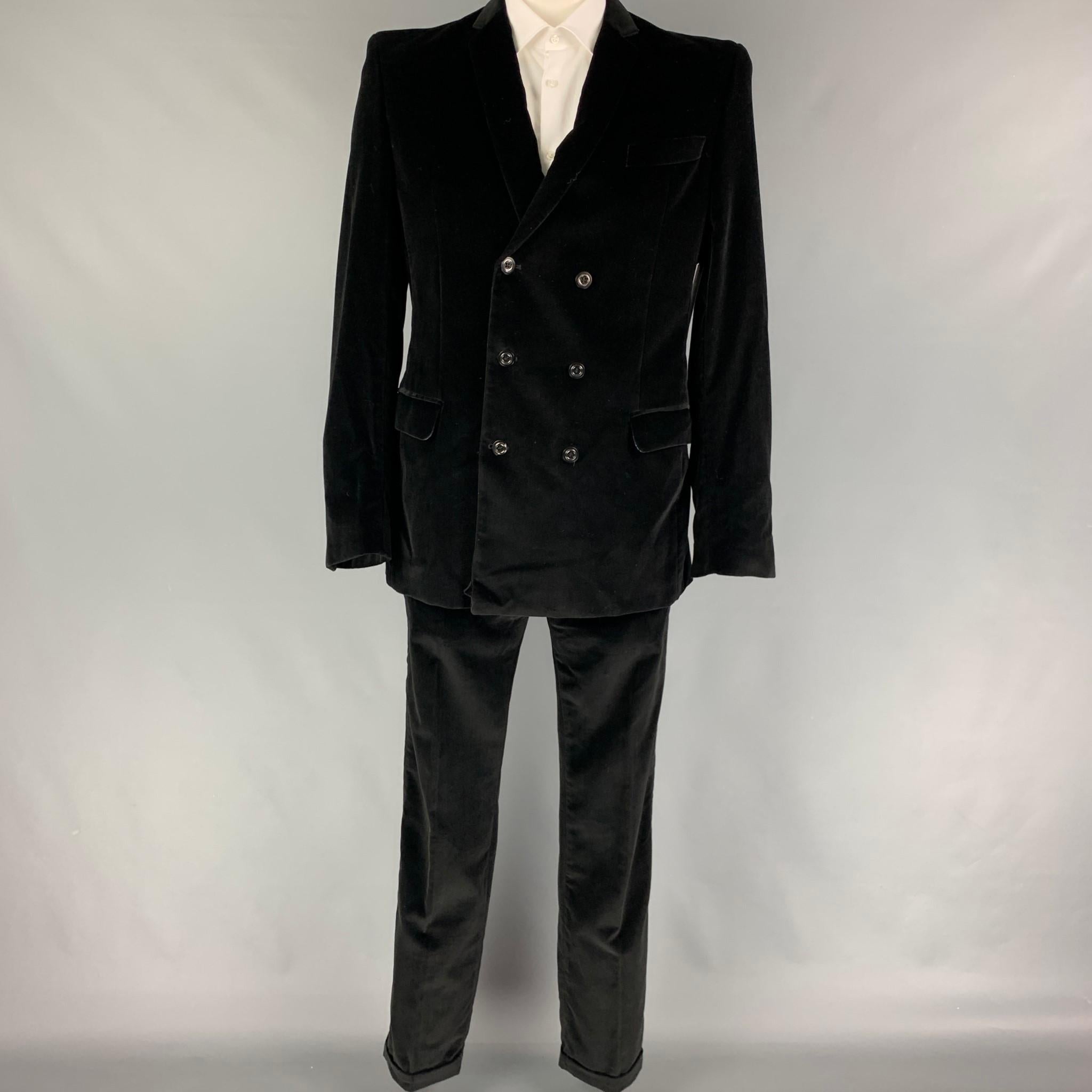 JUST CAVALLI suit comes in a black velvet cotton with a full liner and includes a double breasted sport coat with a notch lapel and matching flat front trousers. Made in Italy.

Very Good Pre-Owned Condition.
Marked: