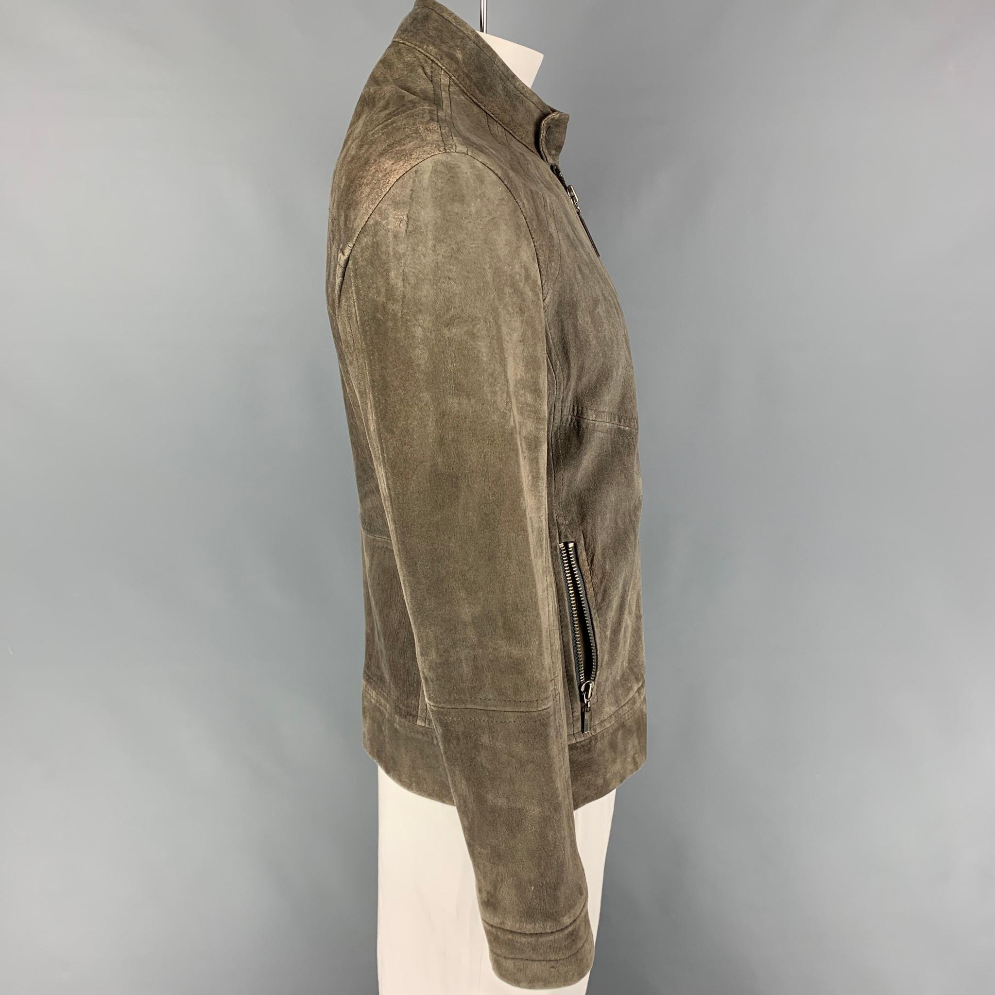 JUST CAVALLI jacket comes in a moss distressed suede featuring a snap button collar strap, zipper pockets, and a full zip up closure. 

Good Pre-Owned Condition. Fabric tag removed.
Marked: Size tag removed.
Original Retail Price: