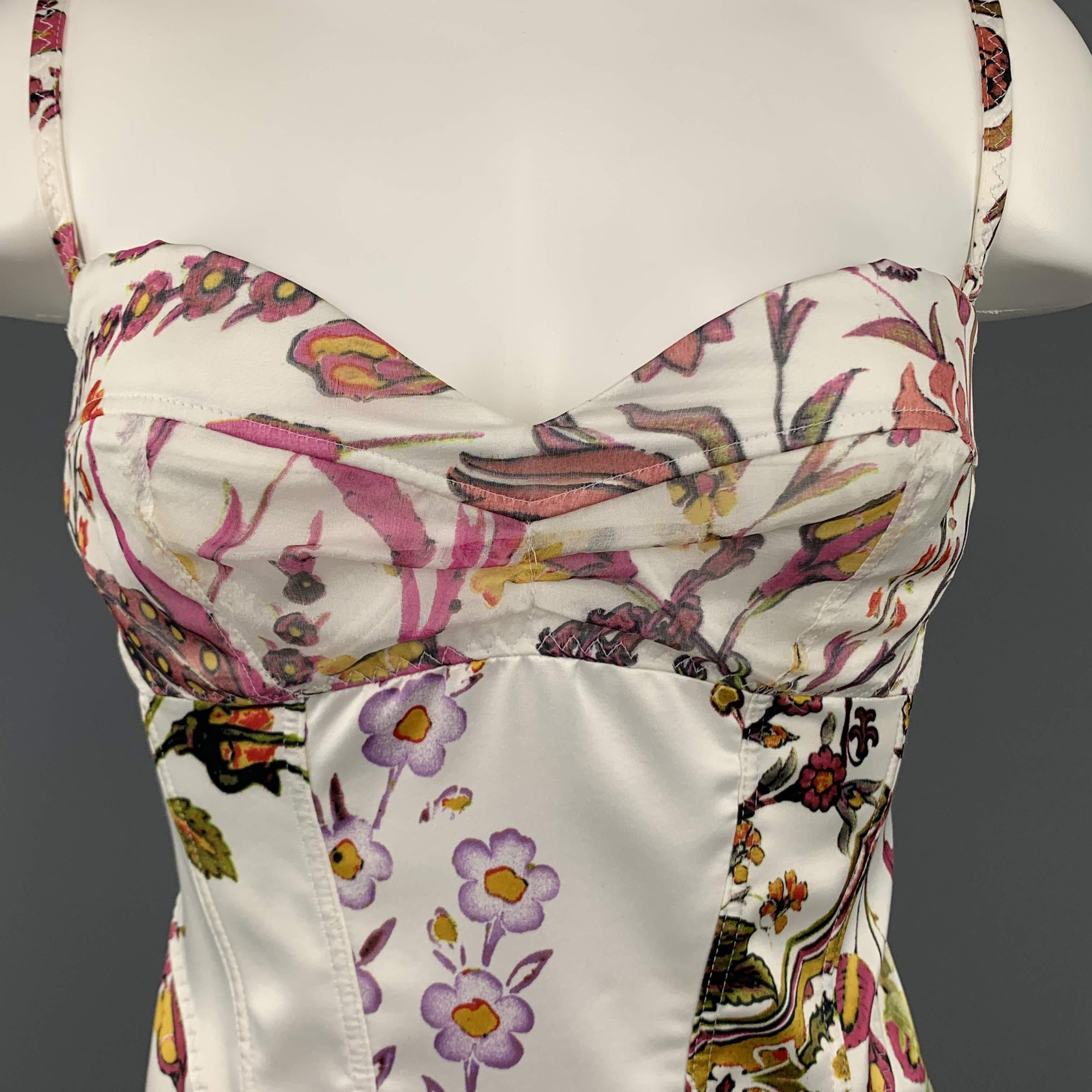 JUST CAVALLI bustier corset top come in white sateen twill with pink, green, gold, and purple floral print, pointed frontal hem, adjustable detachable straps, and chiffon overlay sweetheart neckline. Made in Italy.
 
Excellent Pre-Owned