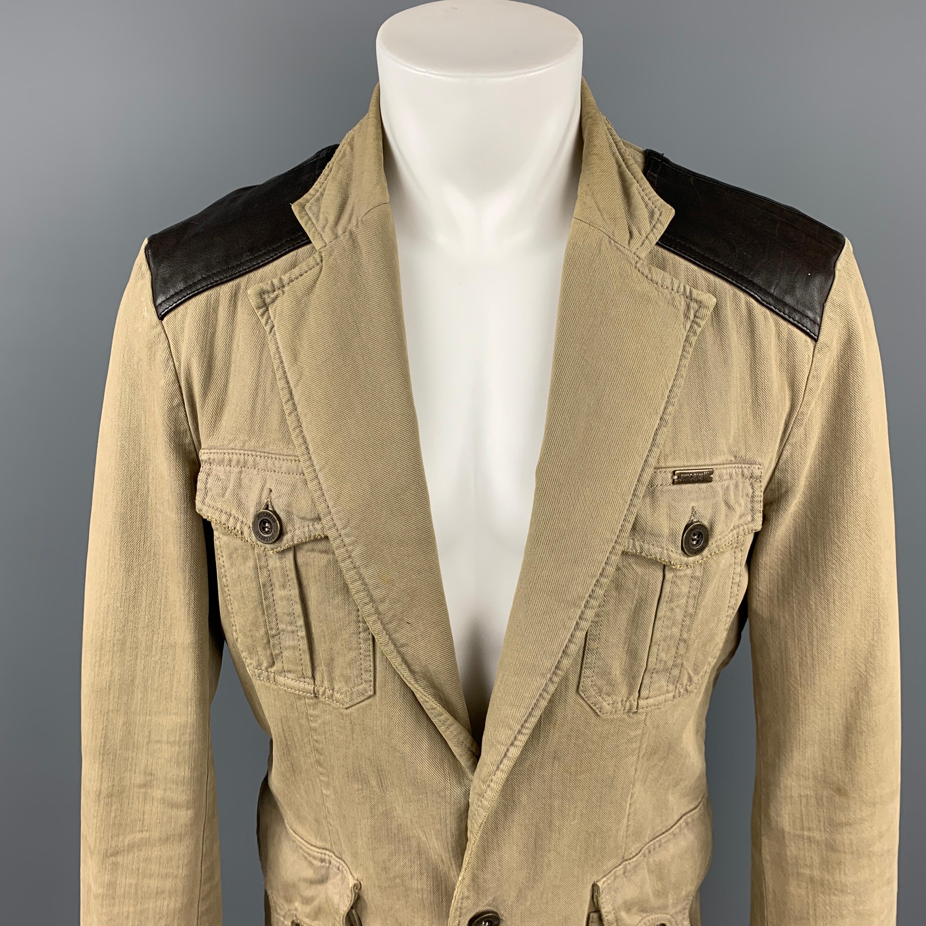 JUST CAVALLI jacket comes in khaki & brown cotton with a leather trim featuring a notch lapel, front pockets, strap detail, and a button closure. Moderate wear. Made in Italy. 

Good Pre-Owned Condition.
Marked: 52

Measurements:

Shoulder: 18.5