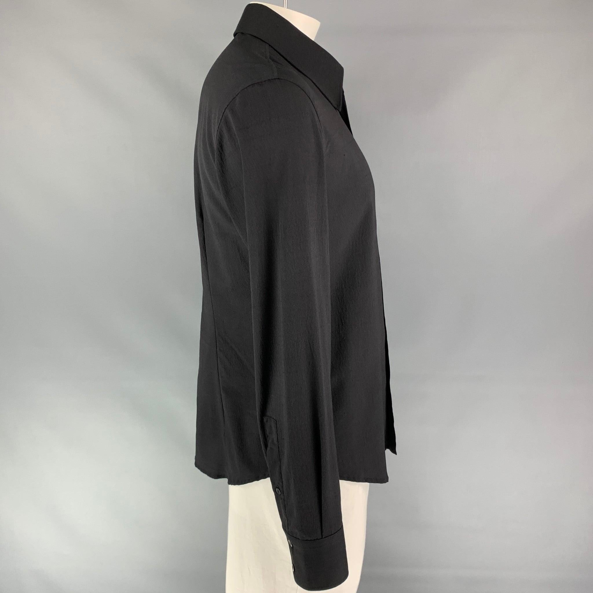 JUST CAVALLI long sleeve shirt comes in a black silk featuring a braided leather trim, spread up, and a button up closure. Made in Italy.Very Good
Pre-Owned Condition. 

Marked:   54 

Measurements: 
 
Shoulder: 20 inches  Chest: 44 inches  Sleeve: