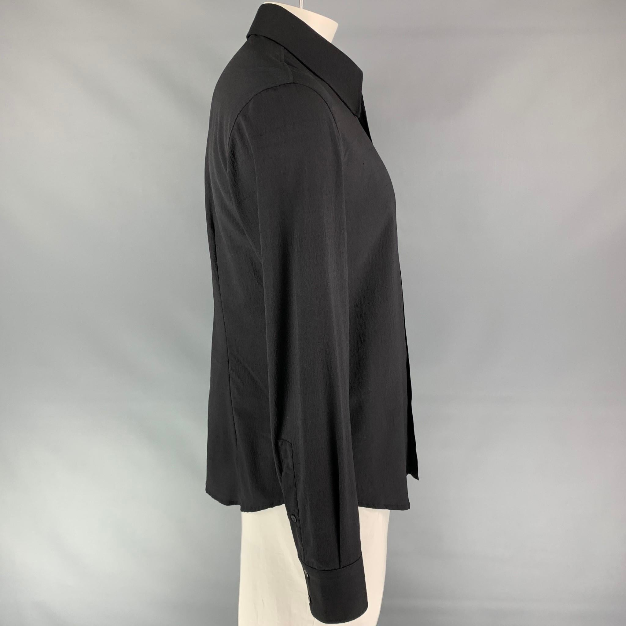 JUST CAVALLI long sleeve shirt comes in a black silk featuring a braided leather trim, spread up, and a button up closure. Made in Italy.

Very Good Pre-Owned Condition.
Marked: 54

Measurements:

Shoulder: 20 in.
Chest: 44 in.
Sleeve: 28