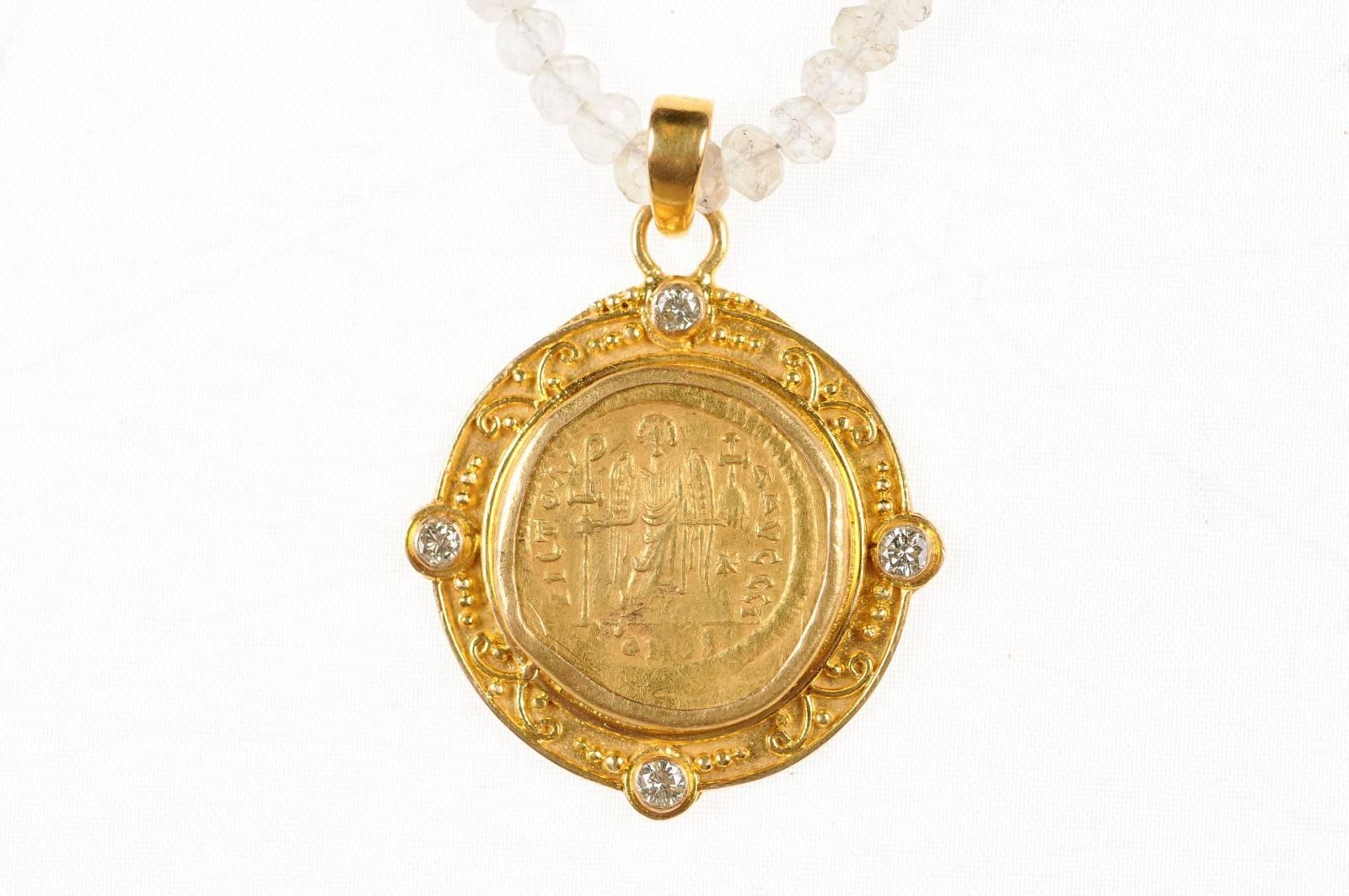 An authentic Justinian I, AV Gold Solidius Roman Imperial Coin (Constantinople Mint, circa 545-563 AD), within a custom round 22-karat gold bezel pendant with decorative accents and diamonds set at four points, and a 22-karat gold bail. The obverse,