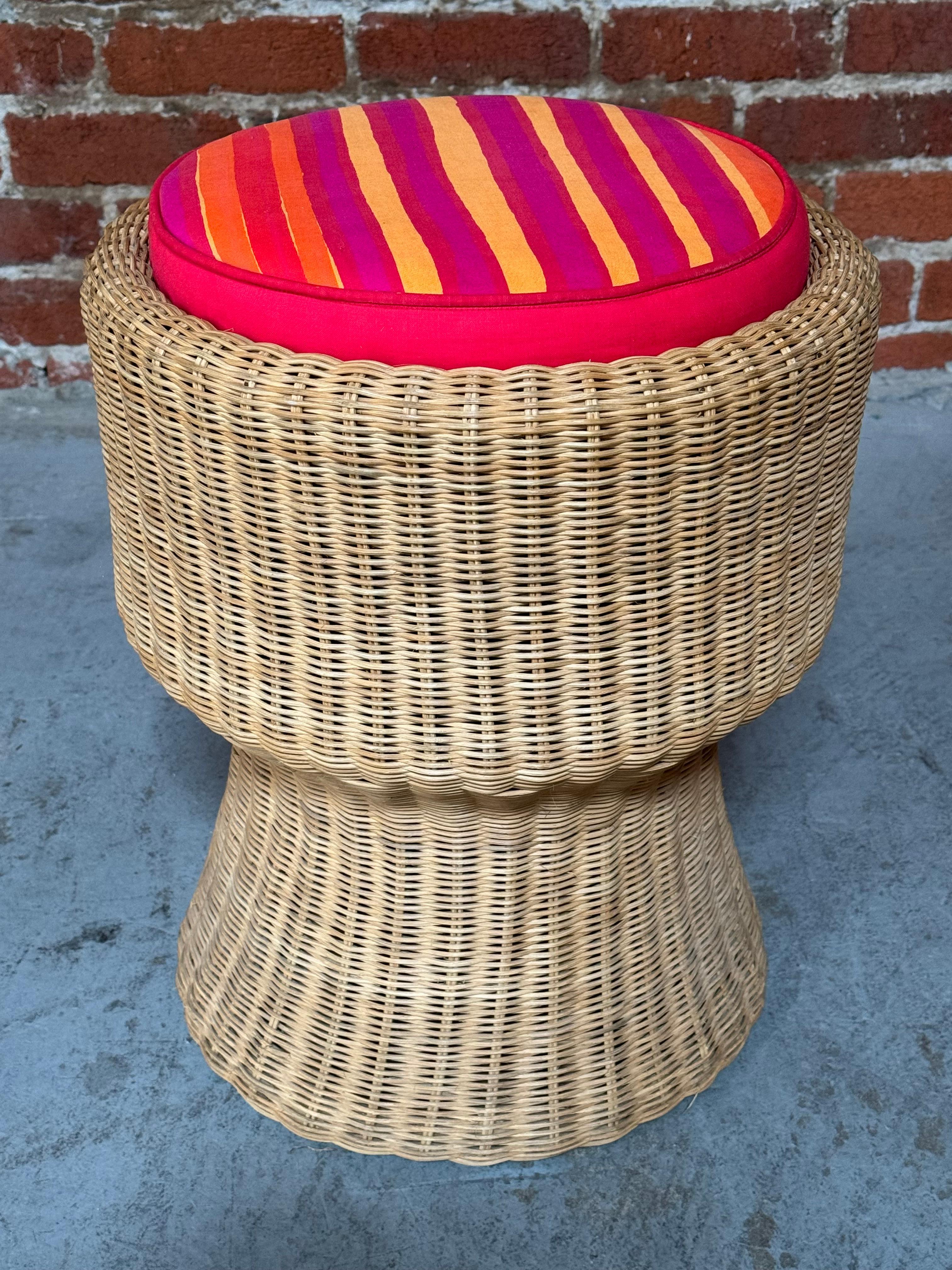 Wicker stool designed by Eero Aarnio for Artek with a Marimekko striped fabric cushion. Handmade wicker base from Finland with indented center in which the cushion can snuggly fit into. The Marimekko cushion is a later addition for a splash of color.