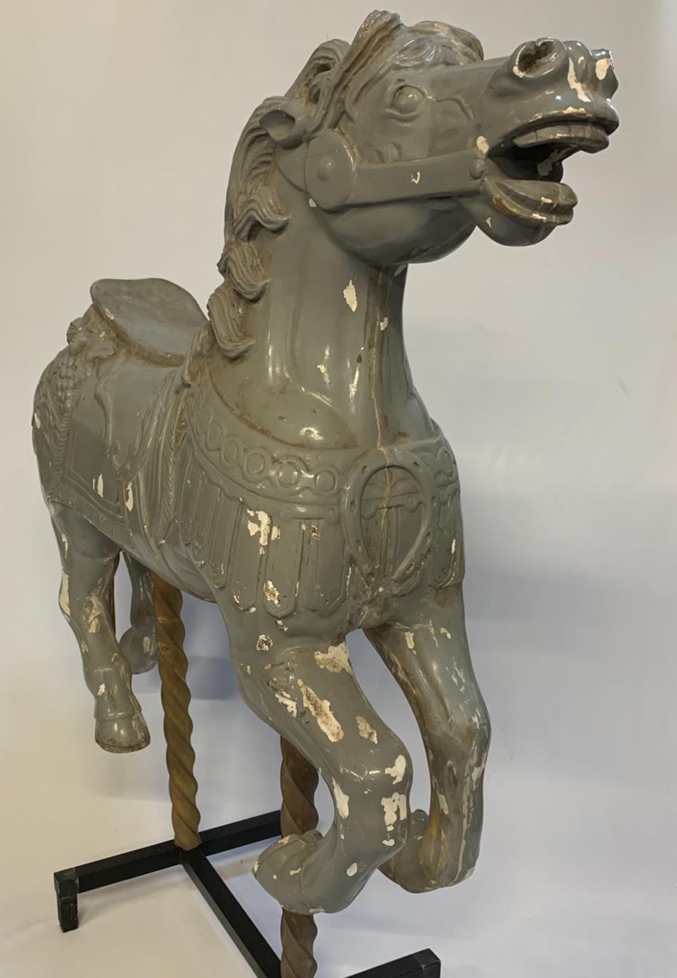 Old juvenile wooden carousel horse in the style of Charles I D Loof and Gustav Denzil 1911. 
Loof built carousels in Coney Island in 1876.
In his lifetime Charles Loof built more than 40 carousels.
Needs some restoration.
Stored in a farm barn