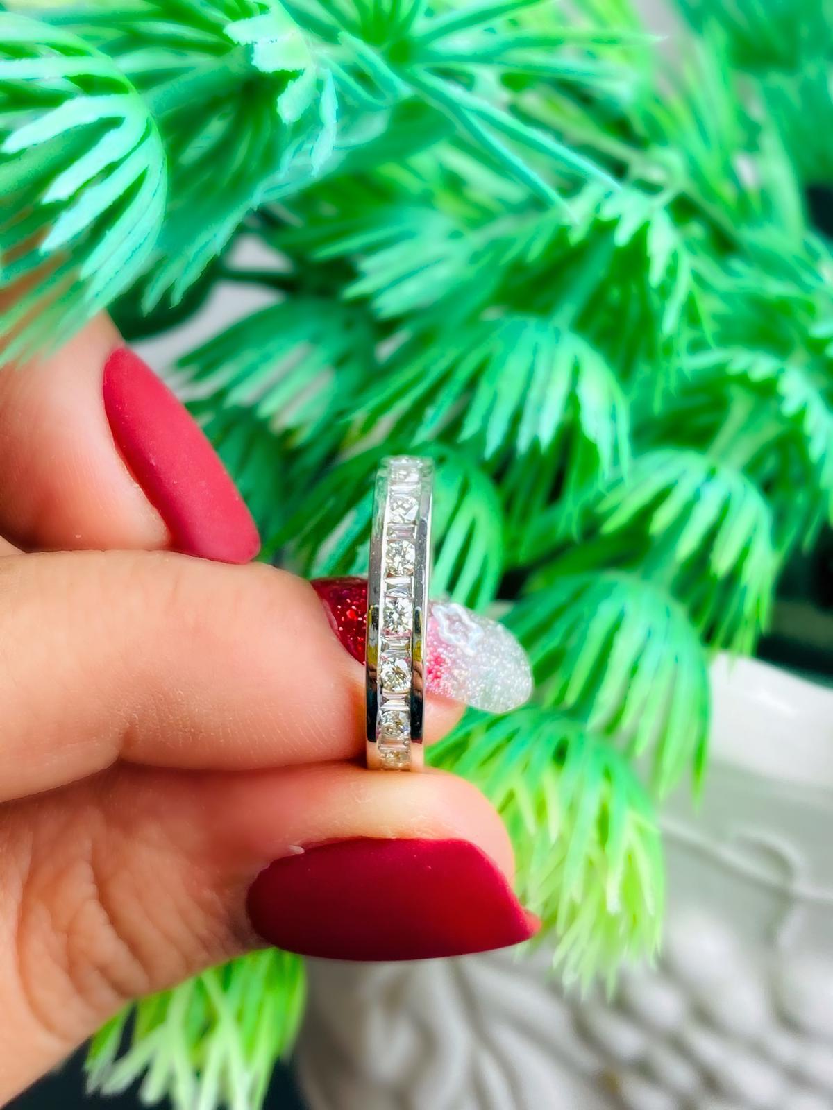 18kt white gold ring with diamonds
  
  Gold colour & Carat: White gold 18kt
  Weight: 3.13 grams
  
  Surrounding Stones: Diamonds
 1) Buguette Diamonds
  Carat weight: 0.32 ct (18 pcs)
  Color: F to G
  Clarity: VS to SI
  Cut: Buguette

2) Round