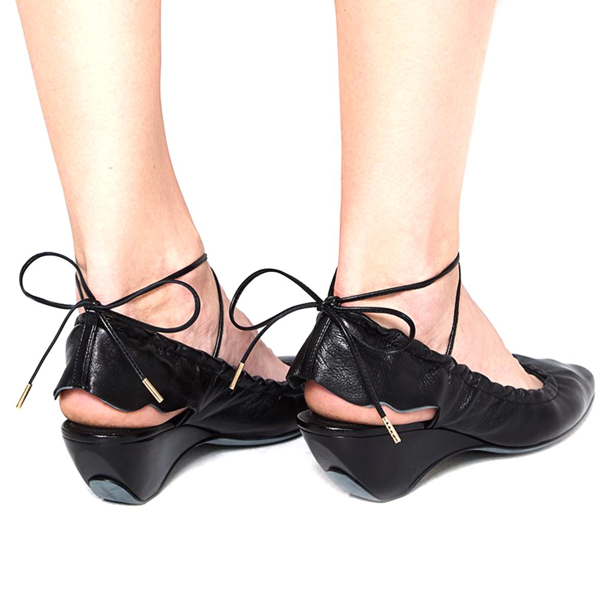  J.W. Anderson Black Leather Tie Back Ballerinas 

- Black Leather Ballerinas 
- Tie back lace-up fastening
- Stretch around heel 
- Round toe
- Open back 
- Curved heel 

This item comes with an additional dust bag. 

Please note, these items are