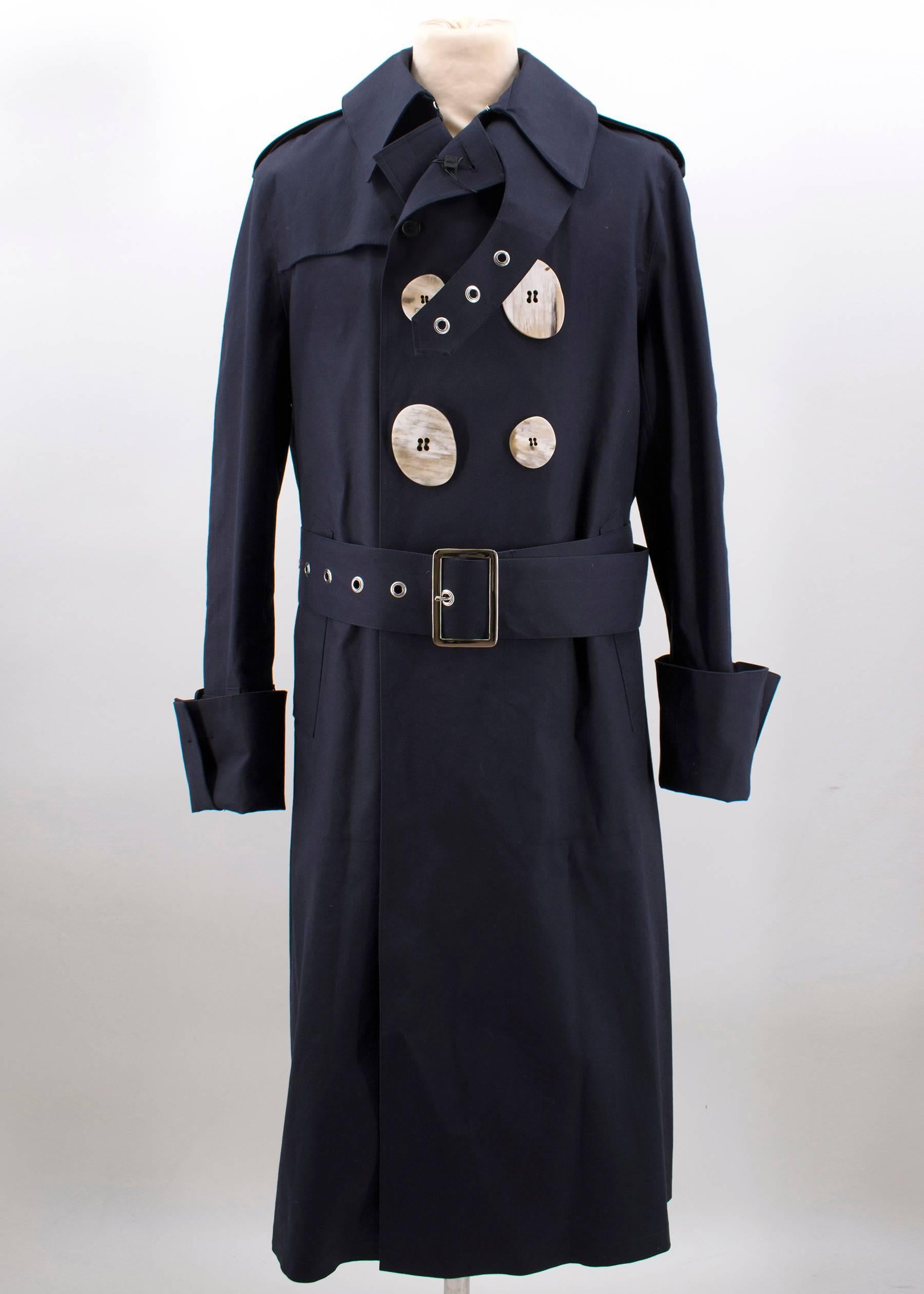 Mackintosh Men's navy trench coat. 
Made in Scotland. 

Collaboration between J.W.Anderson + Mackintosh. 

Genuine handmade. 
100% Cotton bonded. 

Features exaggerated proportions on classic Mackintosh trench, features signature J.W.Anderson horn