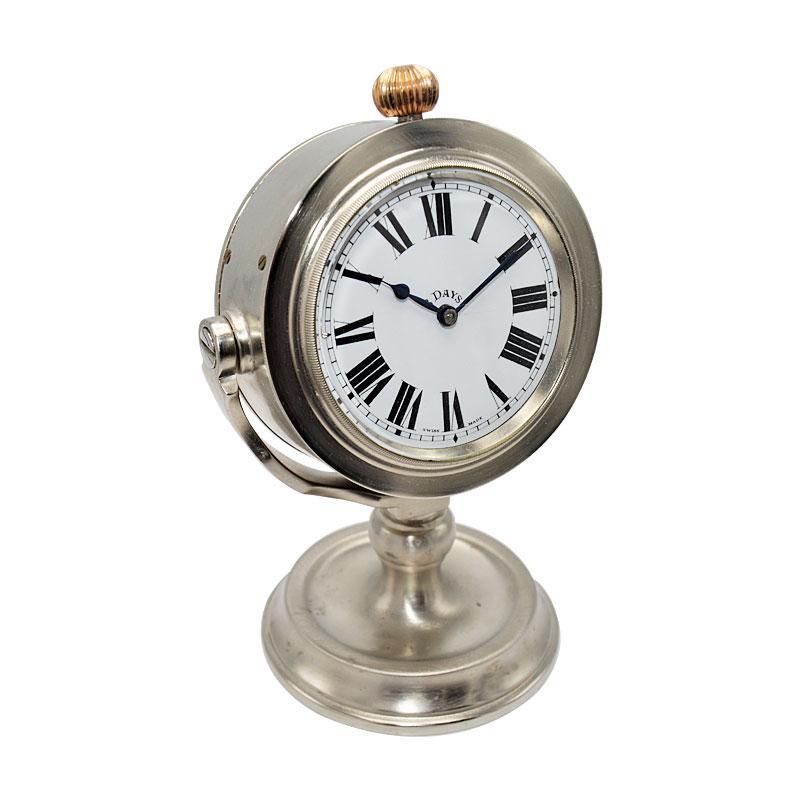 FACTORY / HOUSE: J.W. Benson Watch Company
STYLE / REFERENCE: Nautical Desk Clock
METAL / MATERIAL: Nickel Finished 
CIRCA / YEAR: 1930's
DIMENSIONS / SIZE: 3.5 Inches Wide & 5.5 Inches Tall / 9cm X 14cm
MOVEMENT / CALIBER: Manual Winding / 15