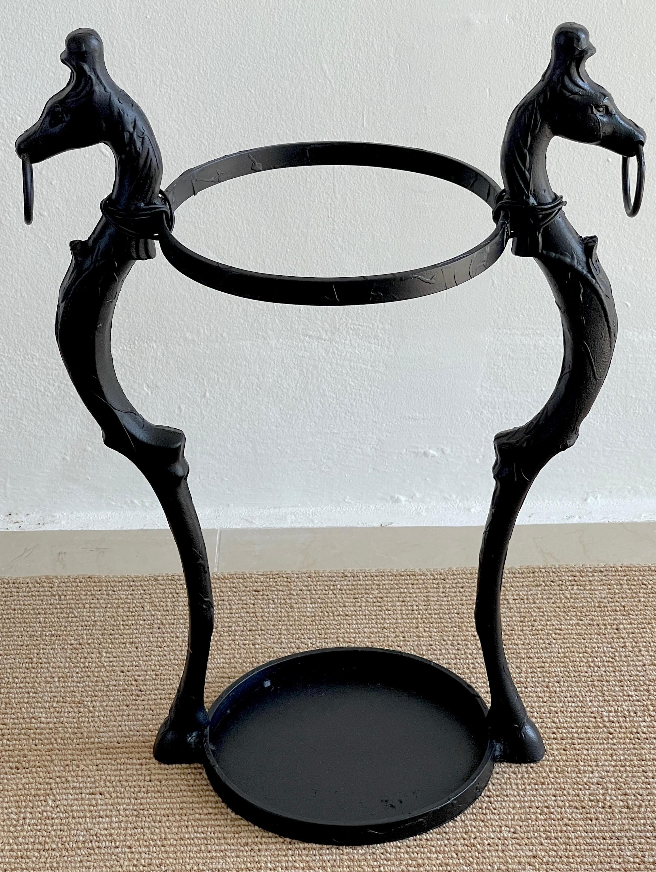 J.W. Fiske Style Victorian Cast iron Horse Motif Umbrella Stand 
 Sculptural in form the twin caryatid horses with rings support the 21- Inch high 11.75 diameter upper ring. The lower part joined by the horses hoof feet, measures 14-Inches wide