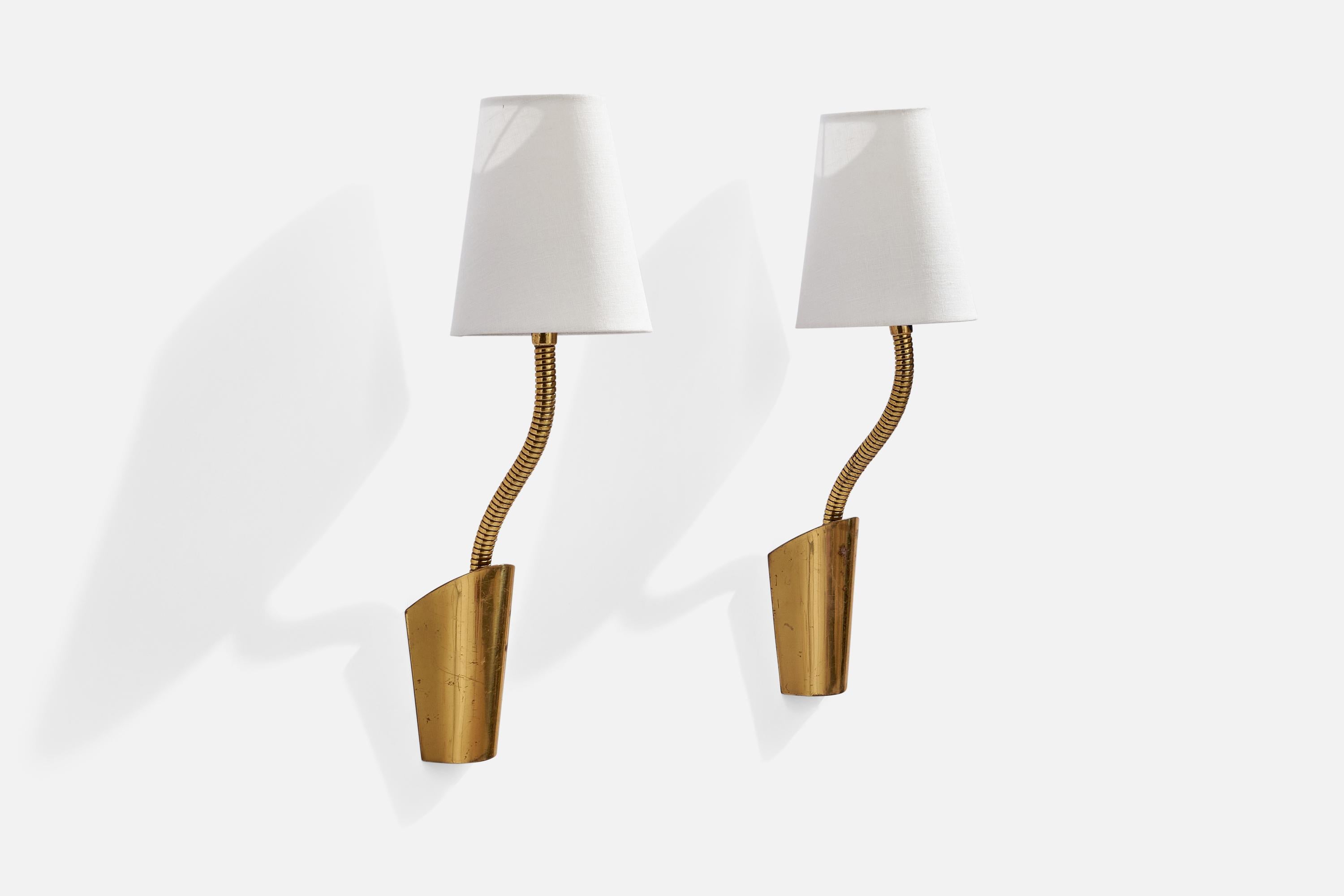 A pair of adjustable brass and fabric wall lights designed and produced by JWA, Sweden, 1950s.

Overall Dimensions (inches): 12” H x 7.5” W x 17.75” D
Back Plate Dimensions (inches): 5.25 H x 3.75” W x 1.5” D
Bulb Specifications: E-26 Bulb
Number of