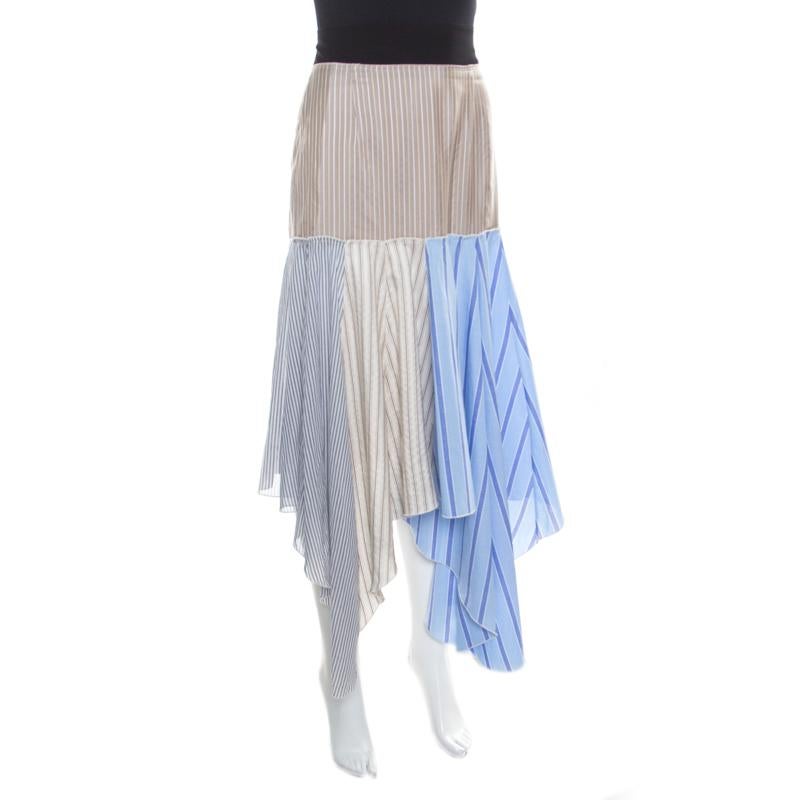 J.W.Anderson's handkerchief skirt is graceful and high on fashion. It is cut to an attractive shape with a blend of fabrics in multicolors, which makes it look fun and casual. The skirt profiles an asymmetric hem and is adorned with a striped