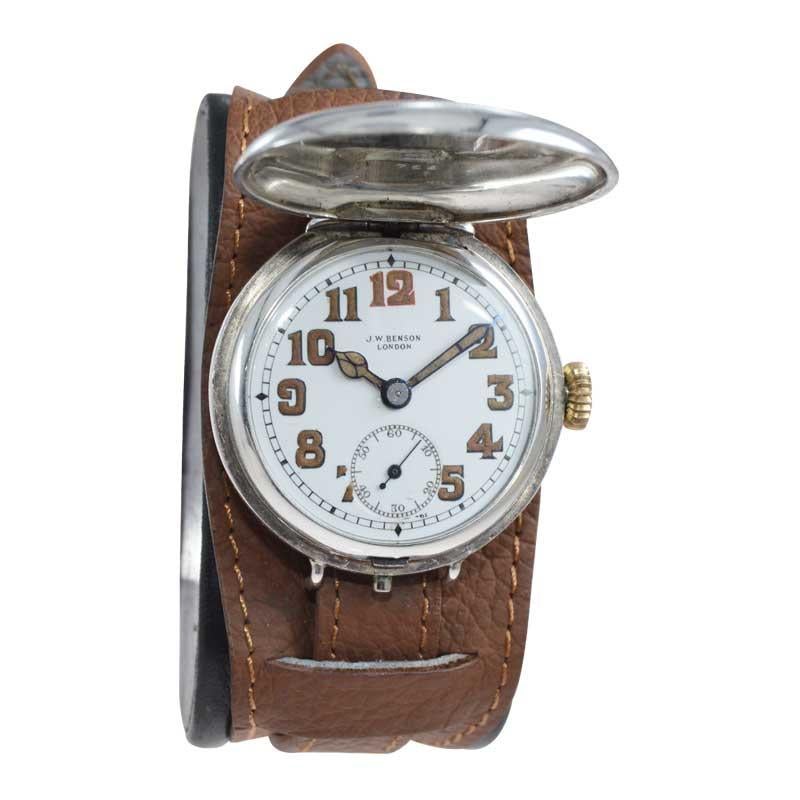 FACTORY / HOUSE: J.W. Benson Watch Co.
STYLE / REFERENCE: Hunters Case / Military Style 
METAL / MATERIAL: Silver
CIRCA / YEAR: 1915
DIMENSIONS / SIZE: Length 39mm x Diameter 34mm
MOVEMENT / CALIBER: Manual Winding / 15 Jewels 
DIAL / HANDS: