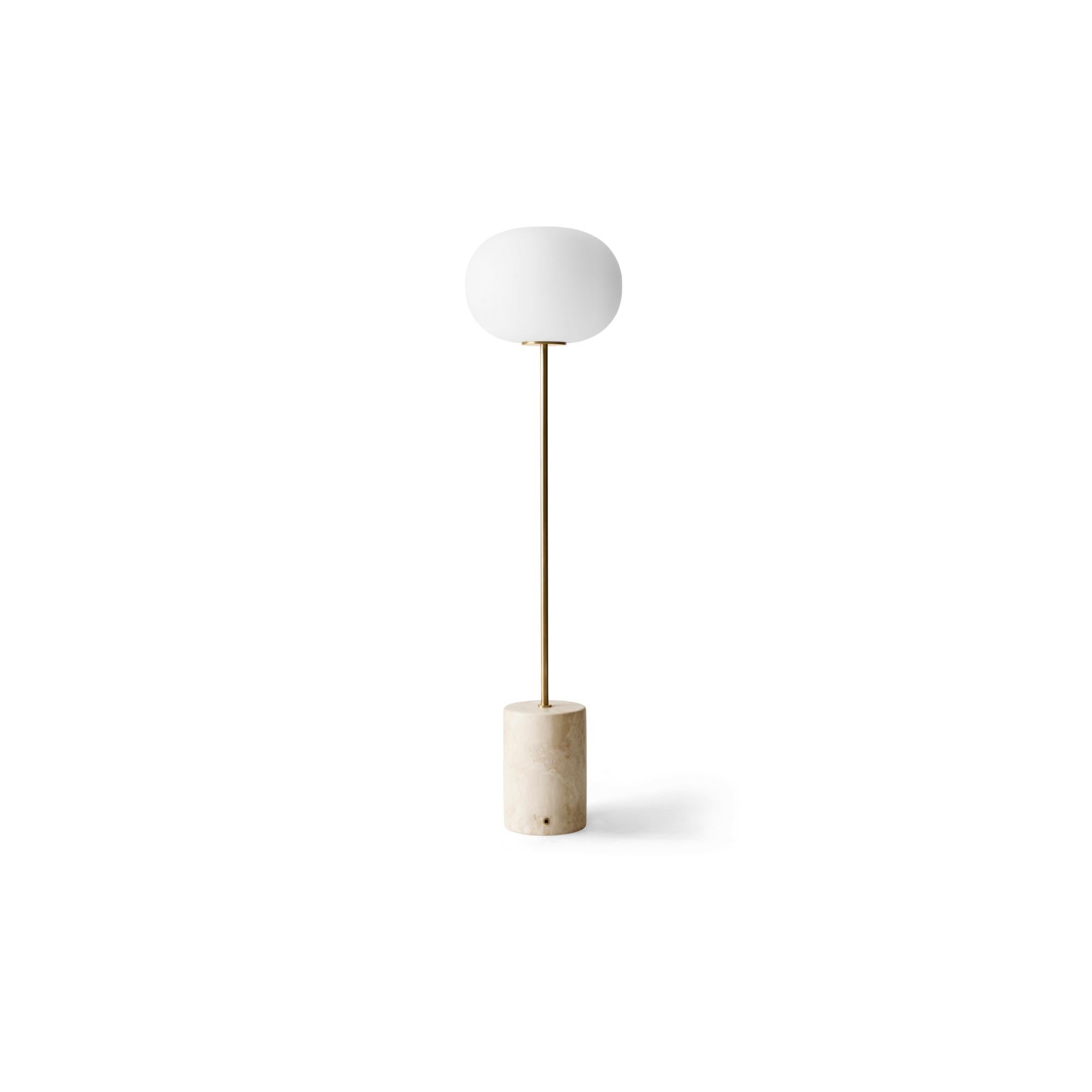 The JWDA floor lamp is part of a collection of lighting inspired by traditional oil lamps. Crafted from contrasting materials, the elegant yet bold design is a lesson in refinement and a study in geometry. An elliptical opal glass shade, a slender
