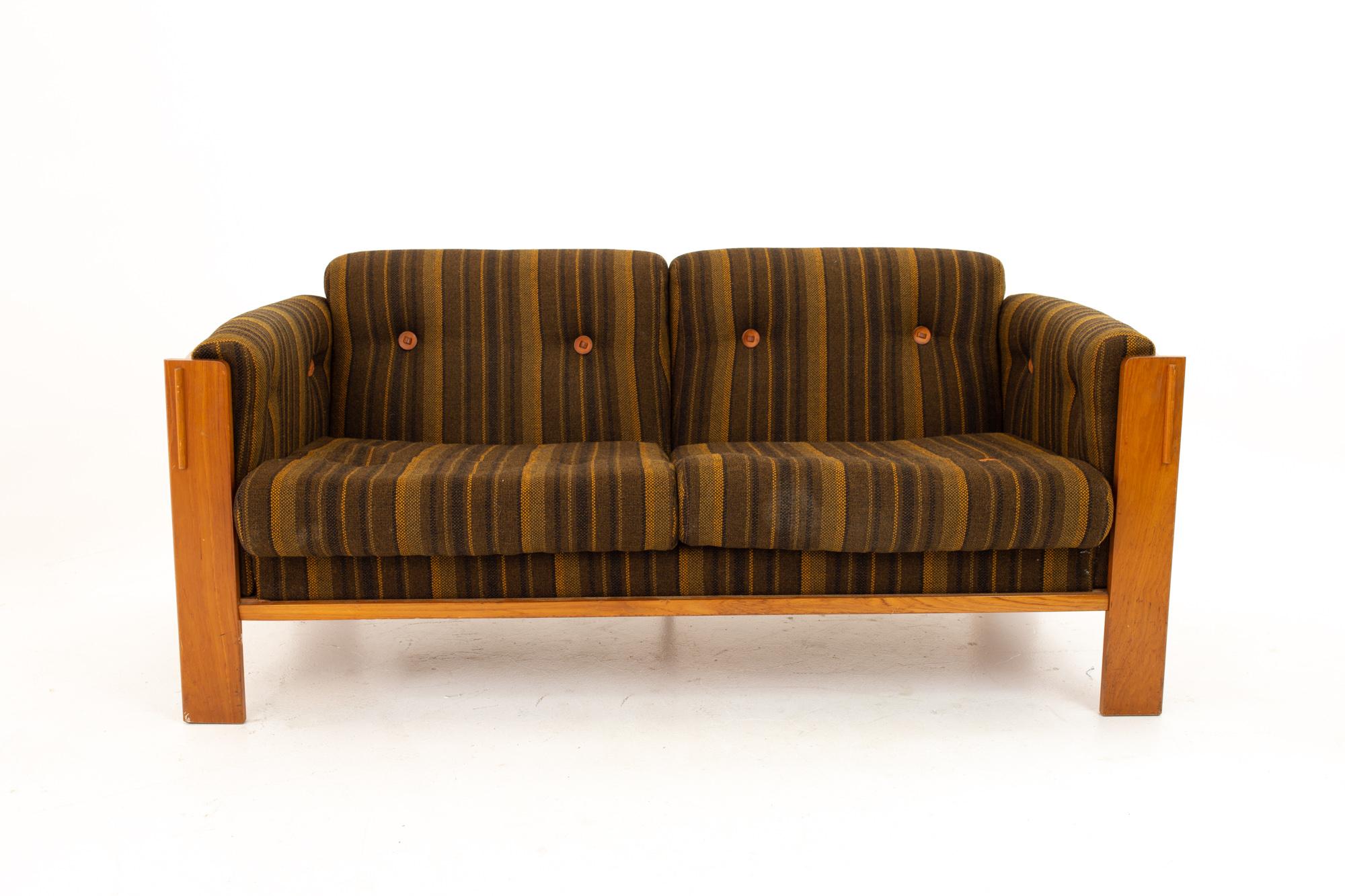 Jydsk Mobelvaerk Mid Century teak loveseat
Loveseat measures: 60 wide x 32 deep x 26 high, with a seat height of 15 inches

This piece is available in what we call restored vintage condition. Upon purchase it is thoroughly cleaned and minor repairs