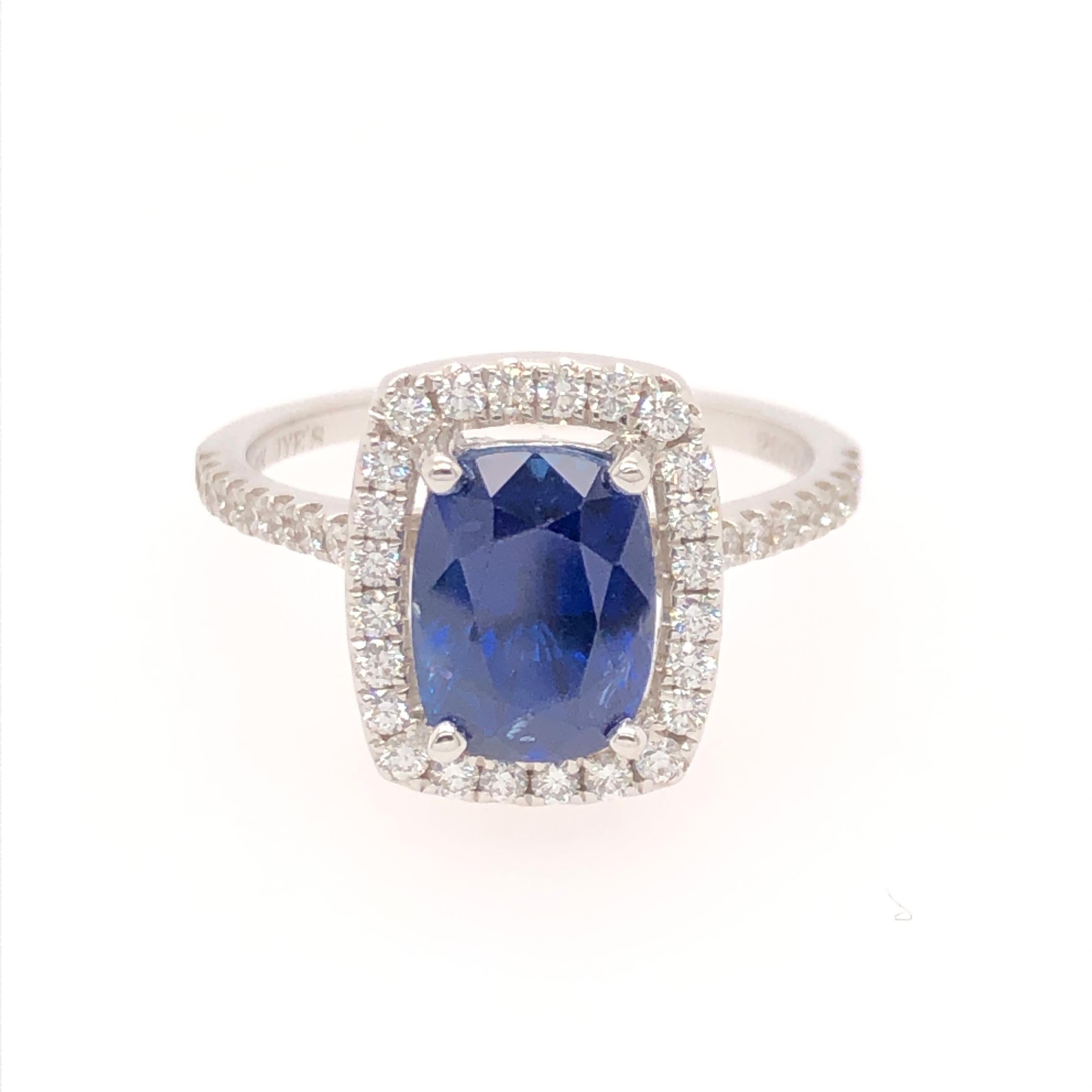 A classic, elegant combination this beautiful 3.13 CT rectangular cushion cut blue sapphire is surrounded  by a halo of round diamonds that flow down the shoulders (total weight .38CT). All is set into an 18 karat white gold ring.

The delicate