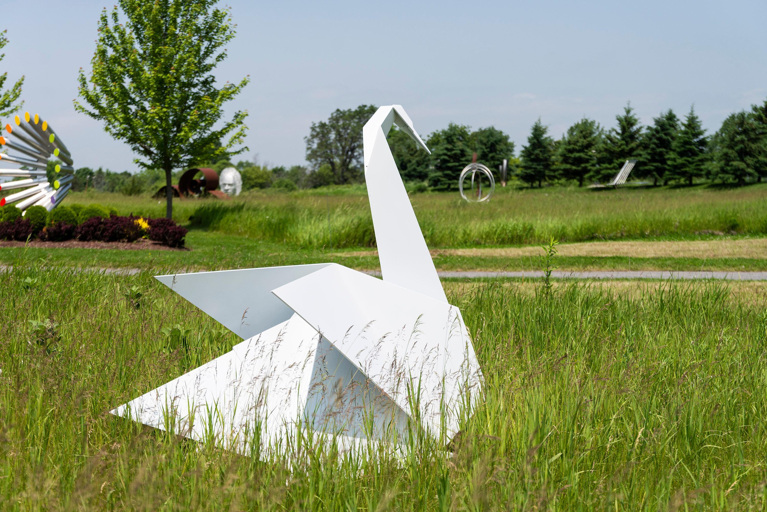 This contemporary metal garden sculpture is made in the form of a white swan.

Jyhling Lee’s beautiful artwork is inspired by the rich traditions and iconic imagery of her culture. As a young child, Lee was taught the ancient art of origami or