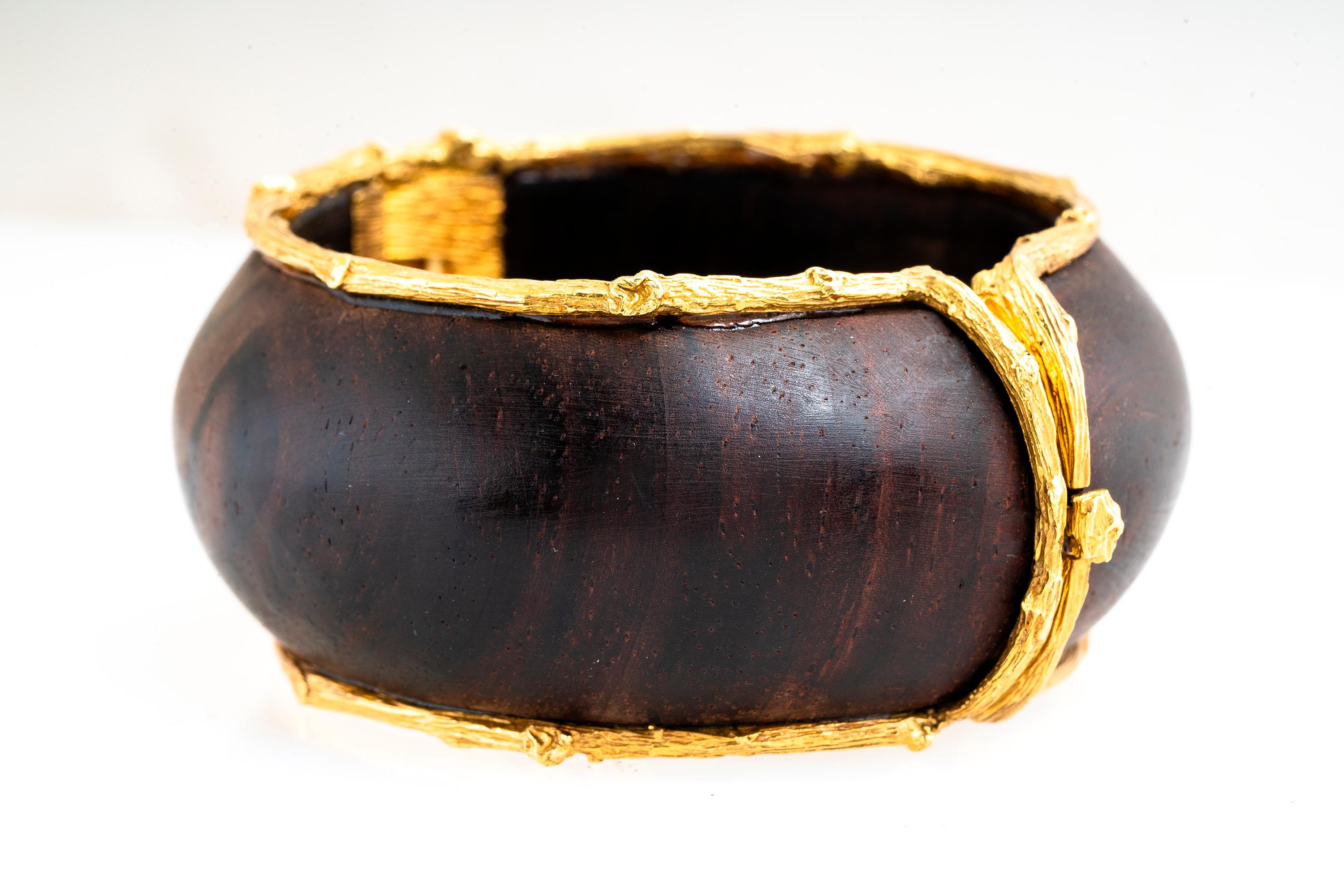 Vintage 18k yellow gold and cocobolo wood twig bamboo bangle bracelet by K. Brunini Jewels.  Bracelet is 1.25 inches wide and will fit a 6-6.25 inch wrist.  Wood grain detailing in the gold trim. Original retail was over $10k.  