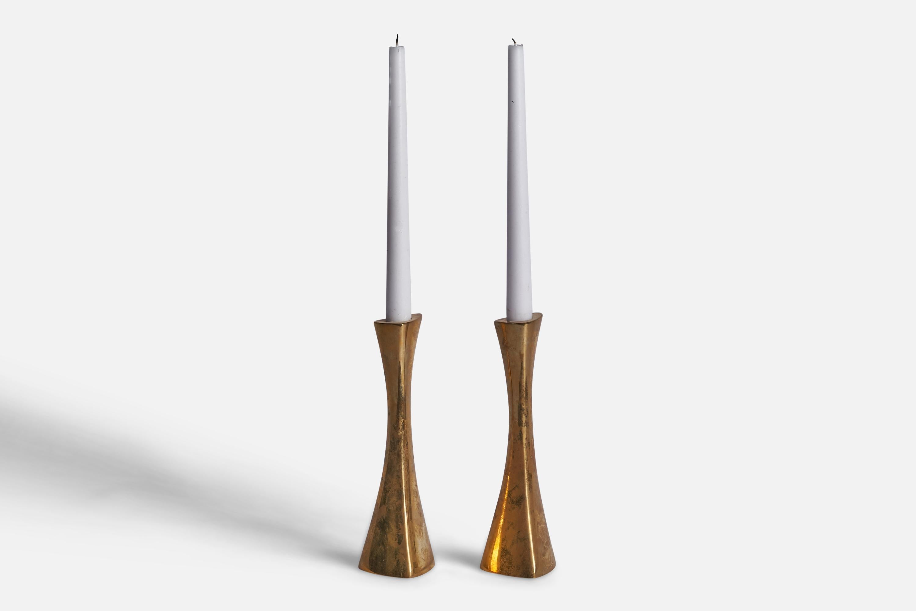 A pair of brass candlesticks designed by K-E Ytterberg and produced by BCA Eskilstuna, Sweden, 1960s.

Fits 0.75” diameter candles