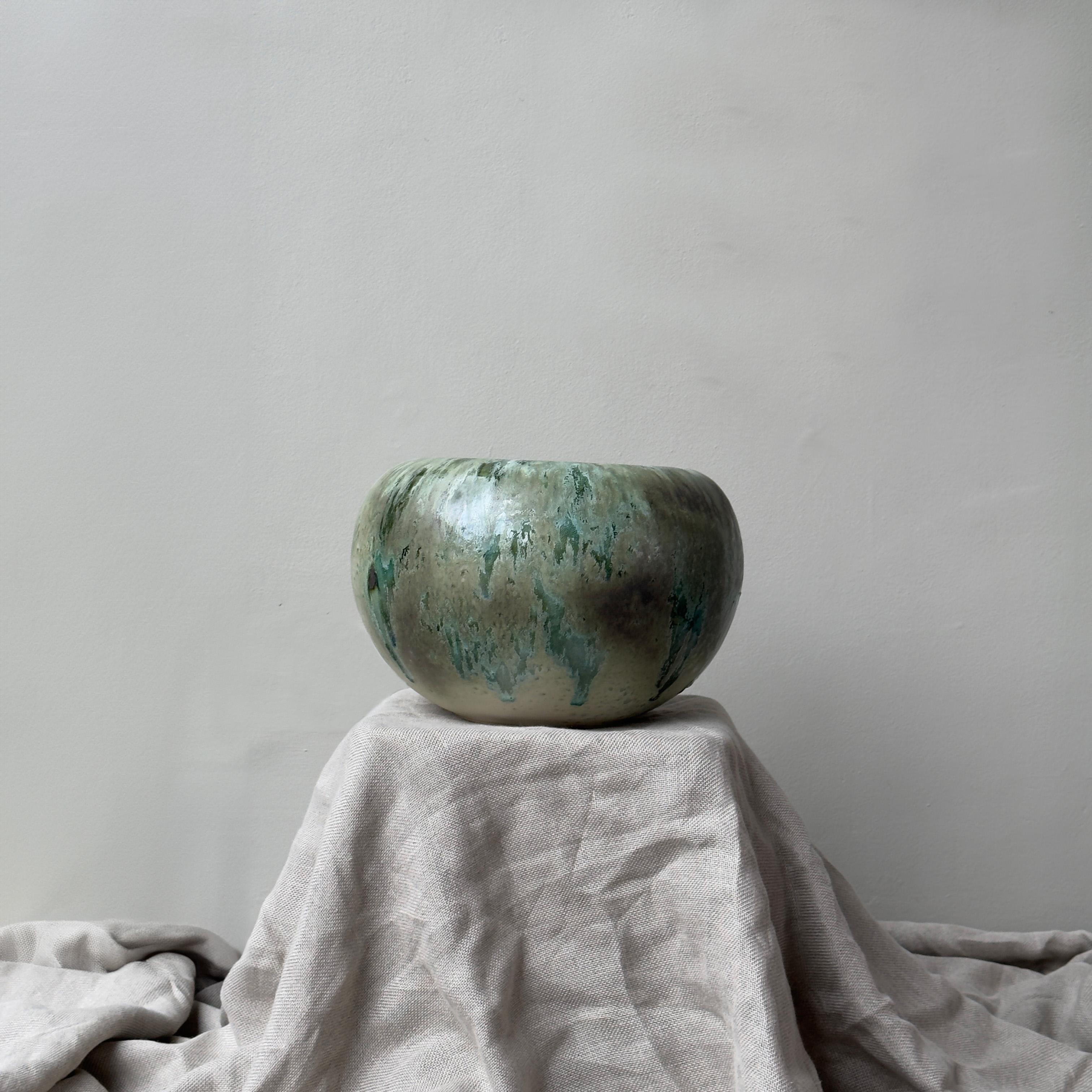 A rotund, tapered vase made and designed in Denmark by K H Würtz. 

This squat vessel by the Danish ceramic studio is adorned with a vivid green glaze. Both vibrant and soft, the glaze of this piece showcases a full spectrum of natural greens and