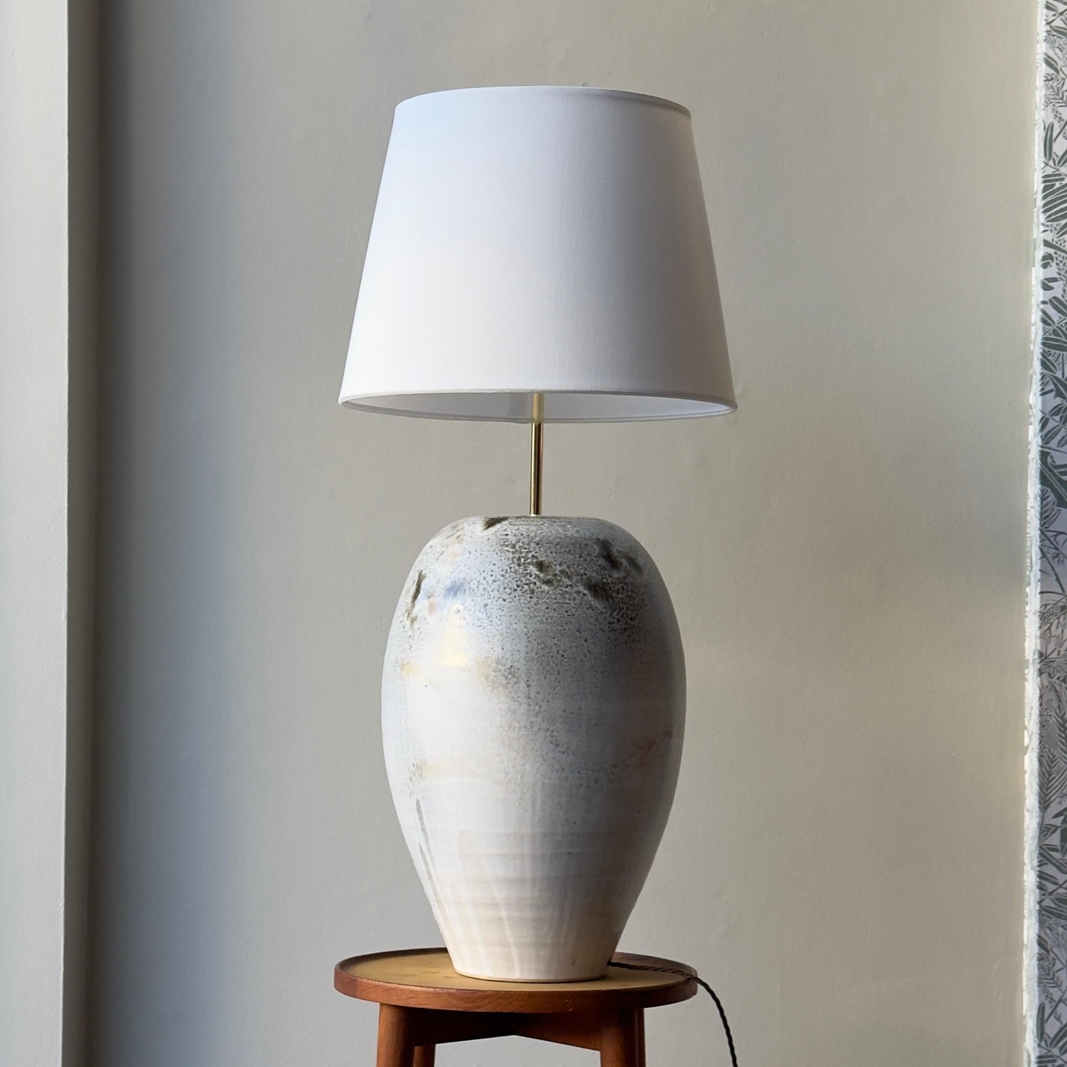 This stoneware lamp comes from the studio of K H Würtz, based near Horsens in eastern Jutland, Denmark.

Known internationally for their hand-thrown and hand-glazed ceramics they have produced bespoke collections for distinguished fine dining