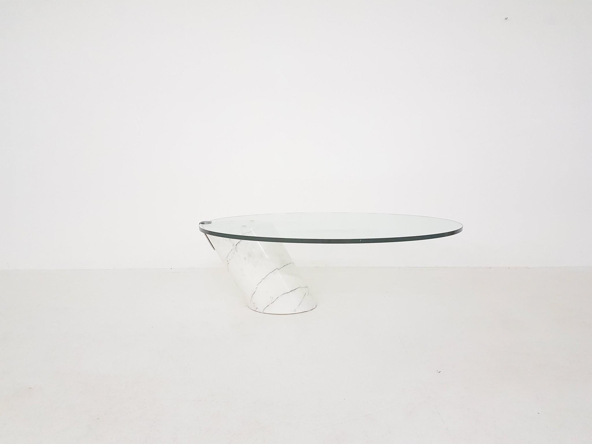 Heavy coffee table made of a massive marble base with a thick glass top. This is a design by Team Form for Ronald Schmitt, Switzerland 1970s.

This design Classic has a glass top which looks like it is floating on top the marble base. The diagonal