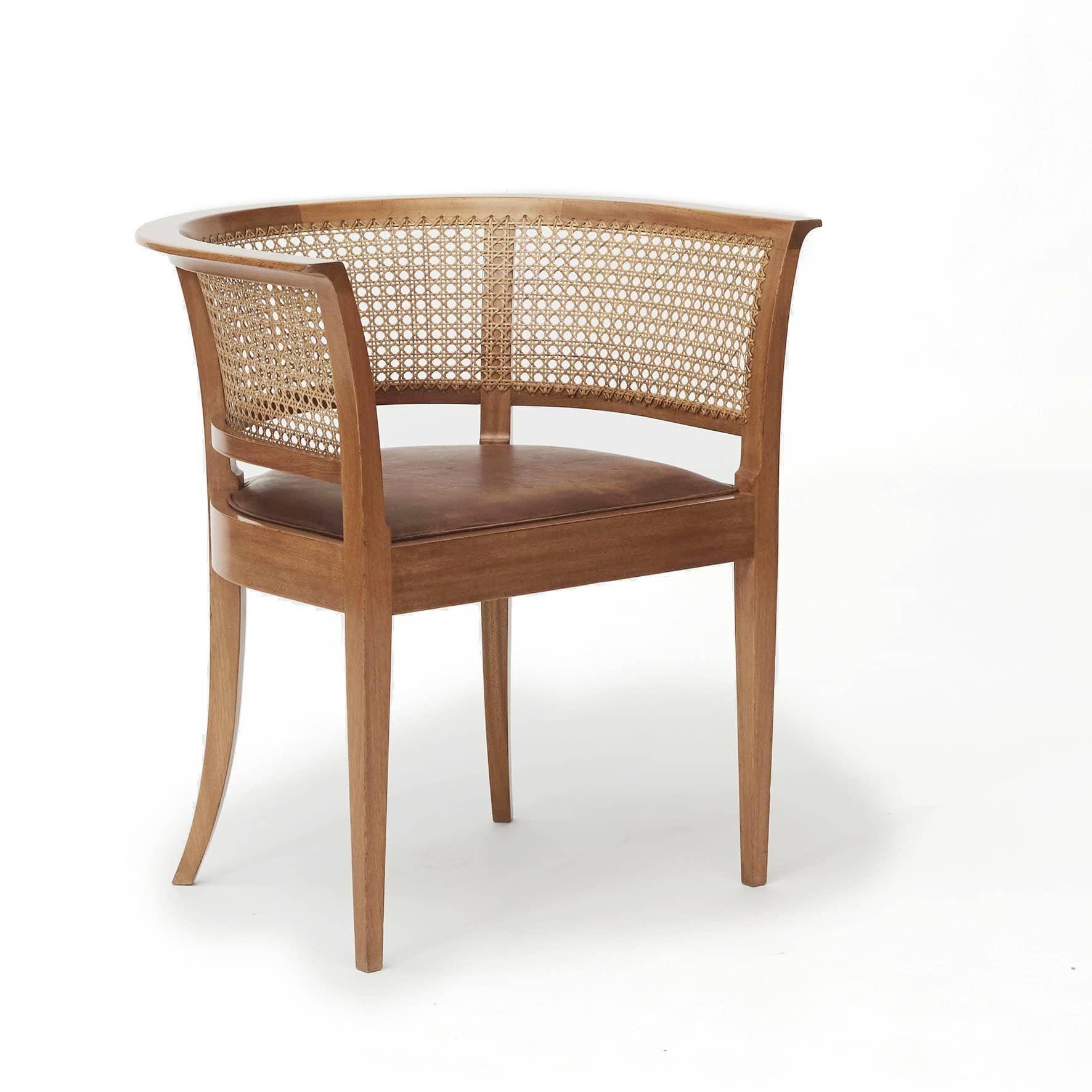 Kaare Klint 1888-1954.
Pair of 'Faaborg chairs' model 9662.
Made of mahogany, back mounted with French wicker, seat upholstered in leather with good age-related patina.

Produced by Snedkermester Rud. Rasmussen with sticker from here. Designed