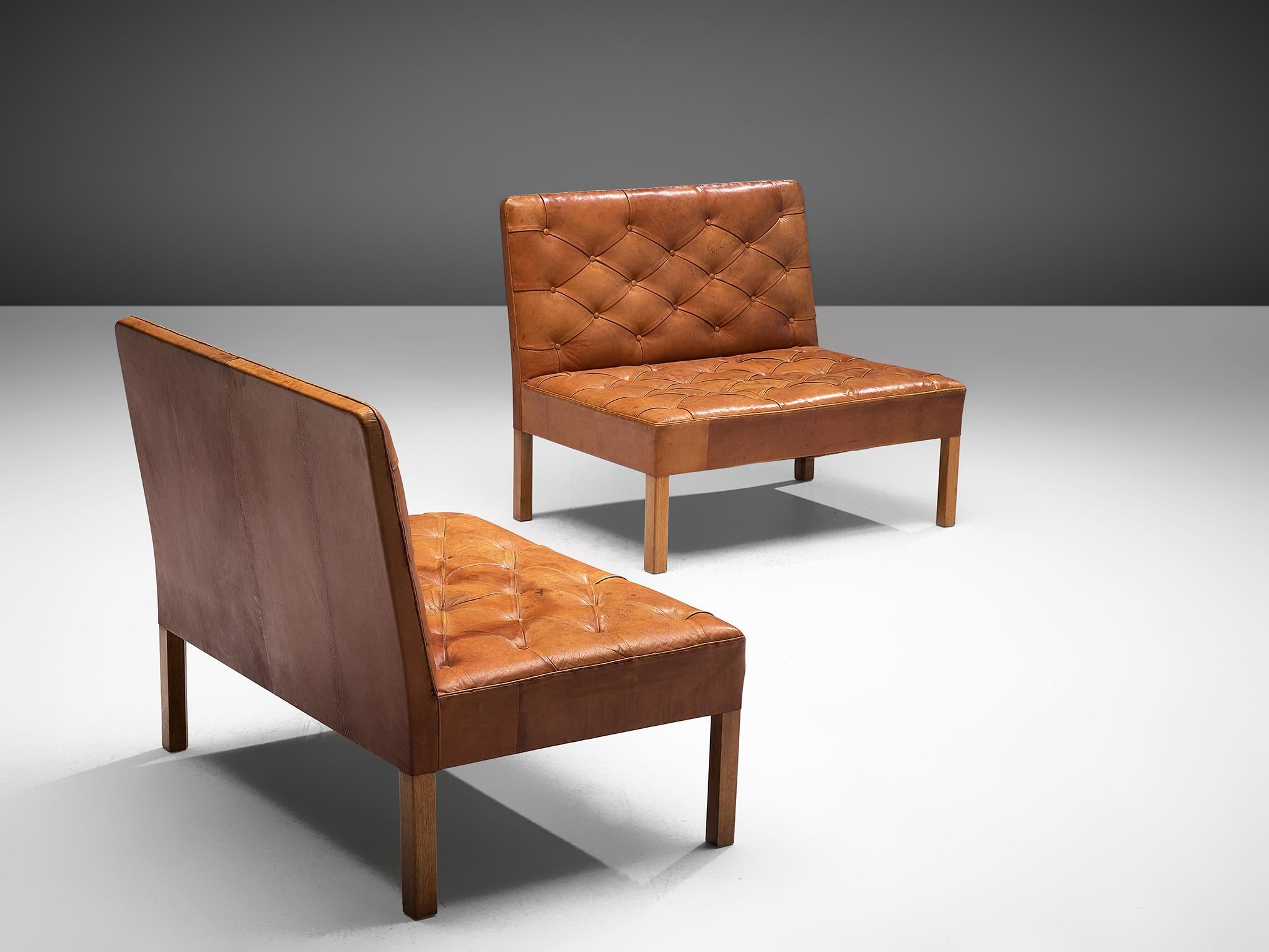 Kaare Klint for Rud Rasmussen, set of two settees model 4698, warm cognac leather and oak, Denmark, 1933, production 1970s. 

This set of freestanding sofas is one of the most iconic designs by Kaare Klint. They show a mix of functional,