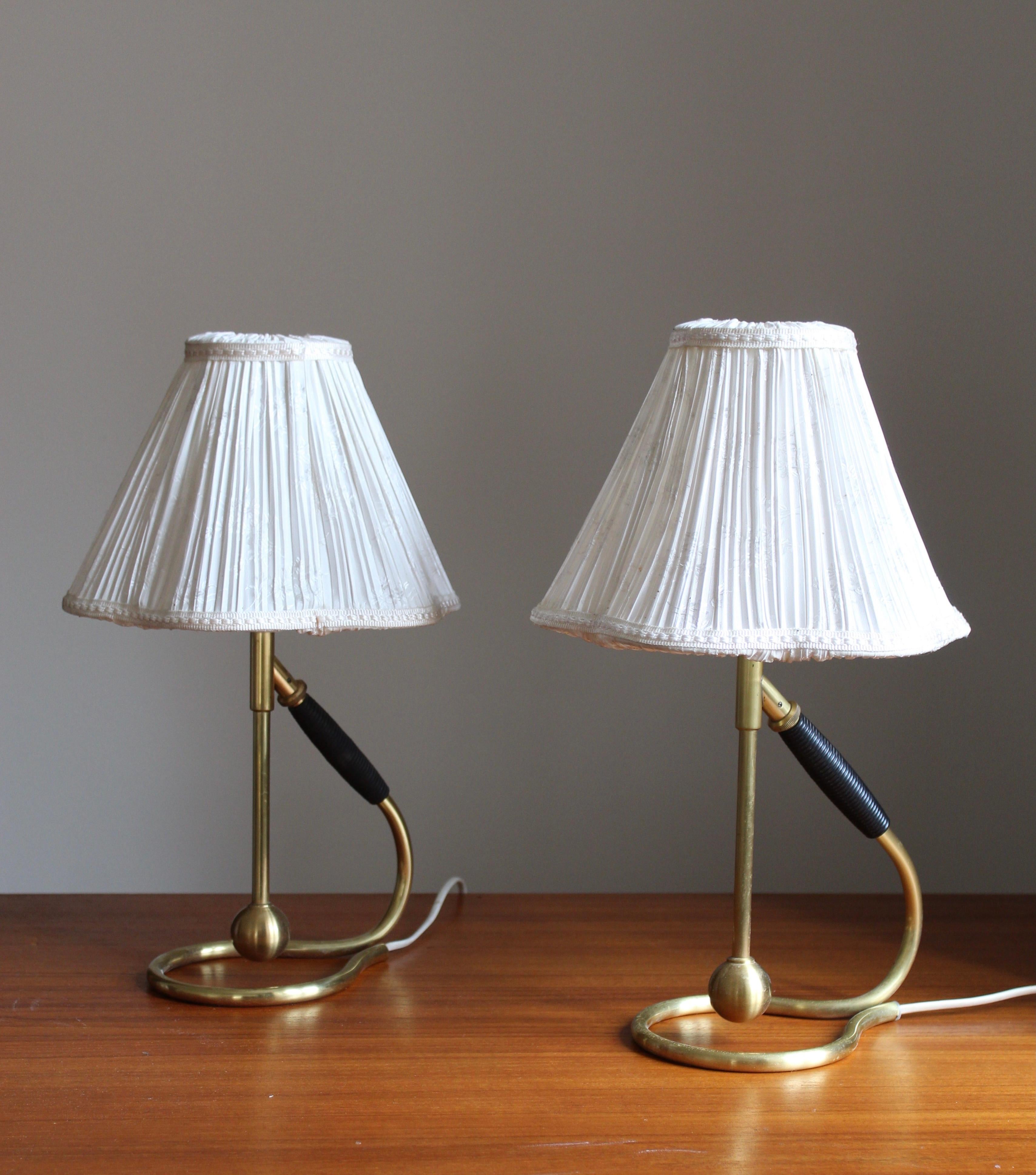 A vintage table lamp by Kaare Klint for Le Klint. Designed in the 1940s. This example produced, circa 1950s-1960s.

With vintage lampshades.

Other designers of the period include Paavo Tynell, Alvar Aalto, Josef Frank, Hans Bergström, and Gino