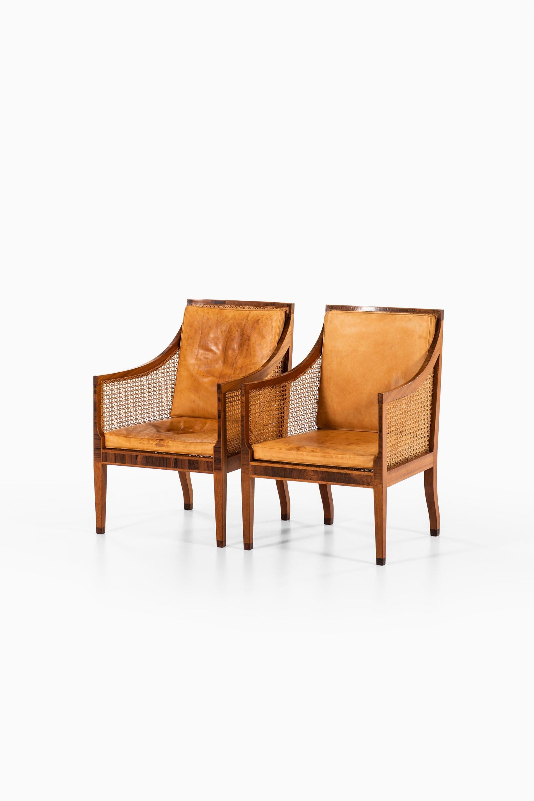 Rare pair of bergère / model 4488 easy chairs designed by Kaare Klint. Produced by Rud. Rasmussen Cabinetmakers in Denmark.