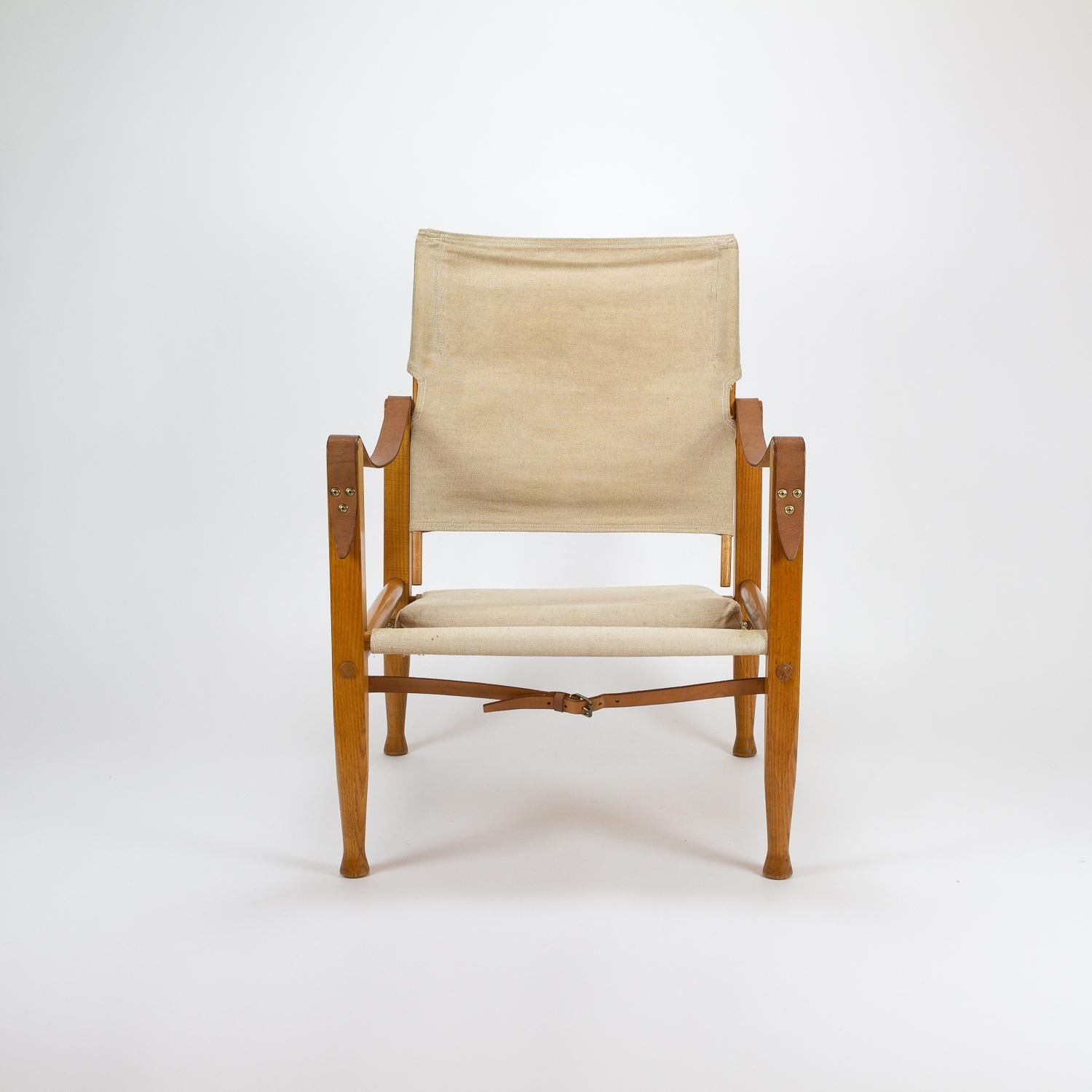 Kaare Klint Safari chair in ash with original canvas seat, cushion and back. In original condition. Designed in 1933 and made by Rud Rasmussen, Denmark, 1950s.