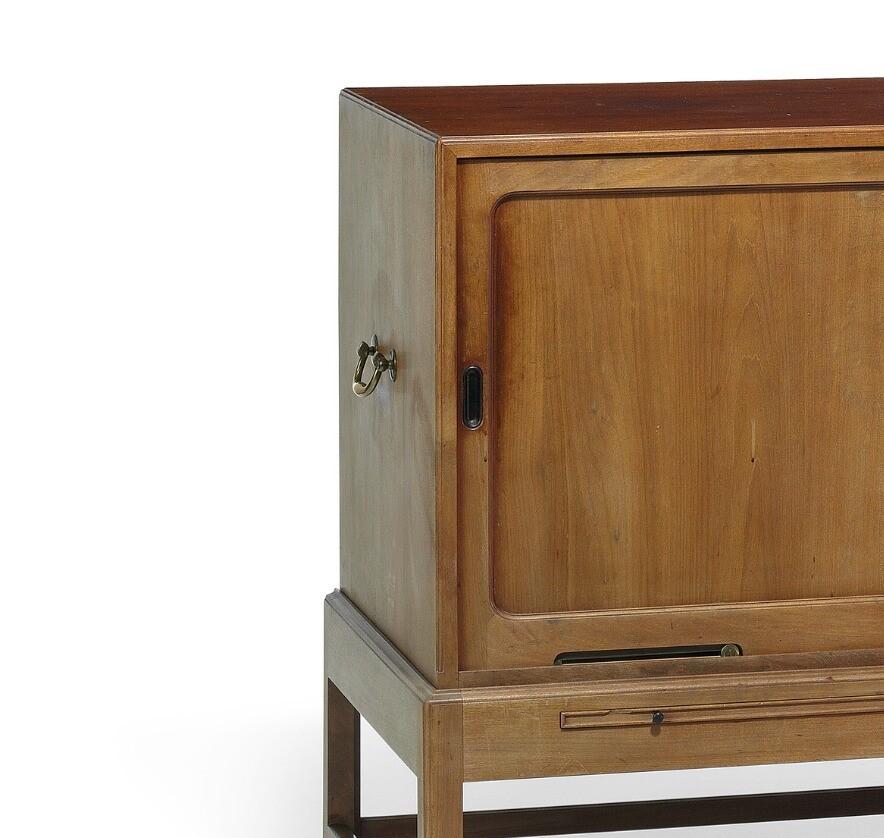 Cuban mahogany sideboard. Front with two sliding doors and two pull-out leaves with handles of black ebony. Interior with trays, sides with large brass handles, brass fittings. Model 4122. Designed 1930. This example made 1930s by Rud. Rasmussen