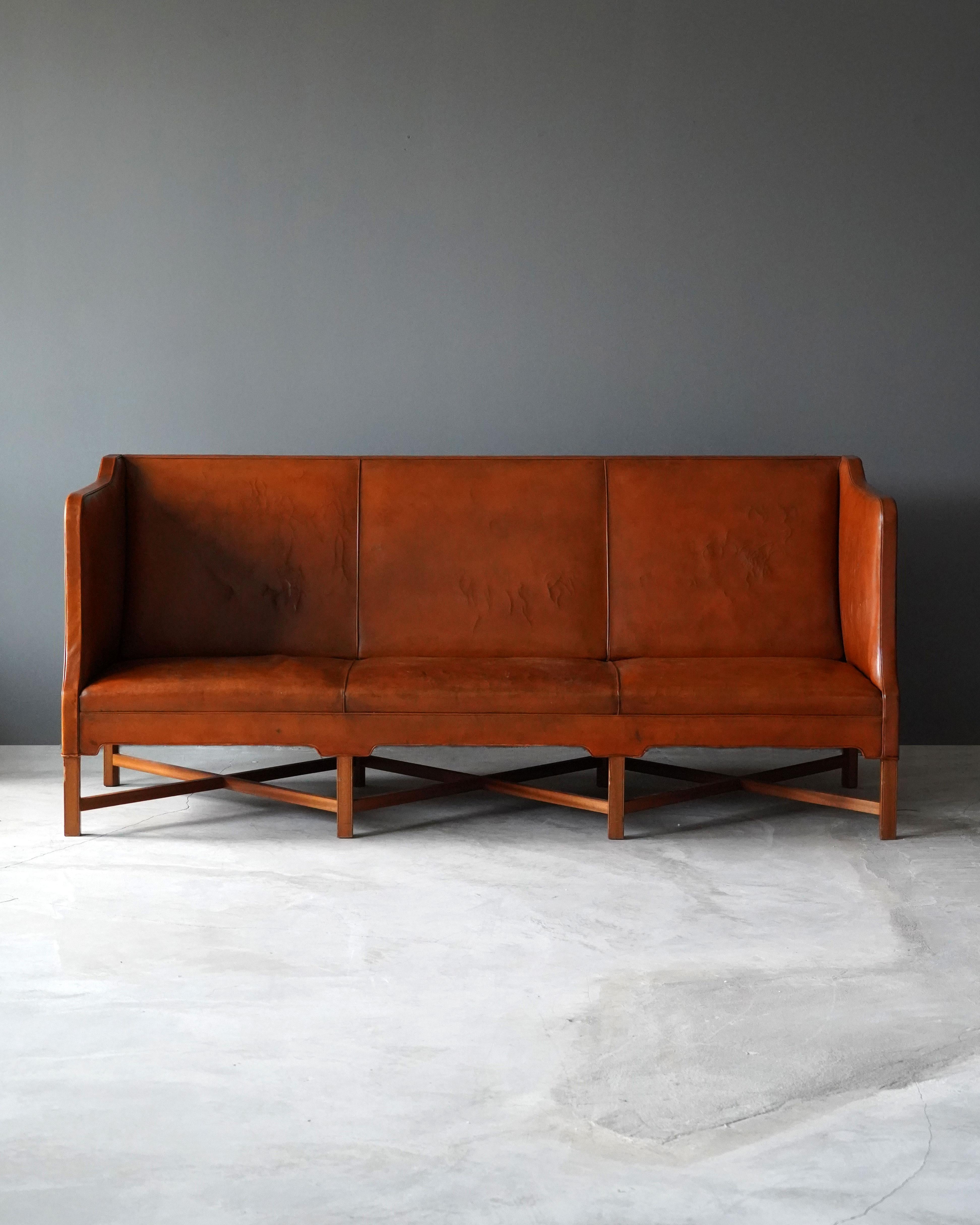An early all-original sofa. Designed by Kaare Klint, produced by cabinetmaker rud Rasmussen, Denmark, c. 1940s. Designed in 1937.

Legs in mahogany.