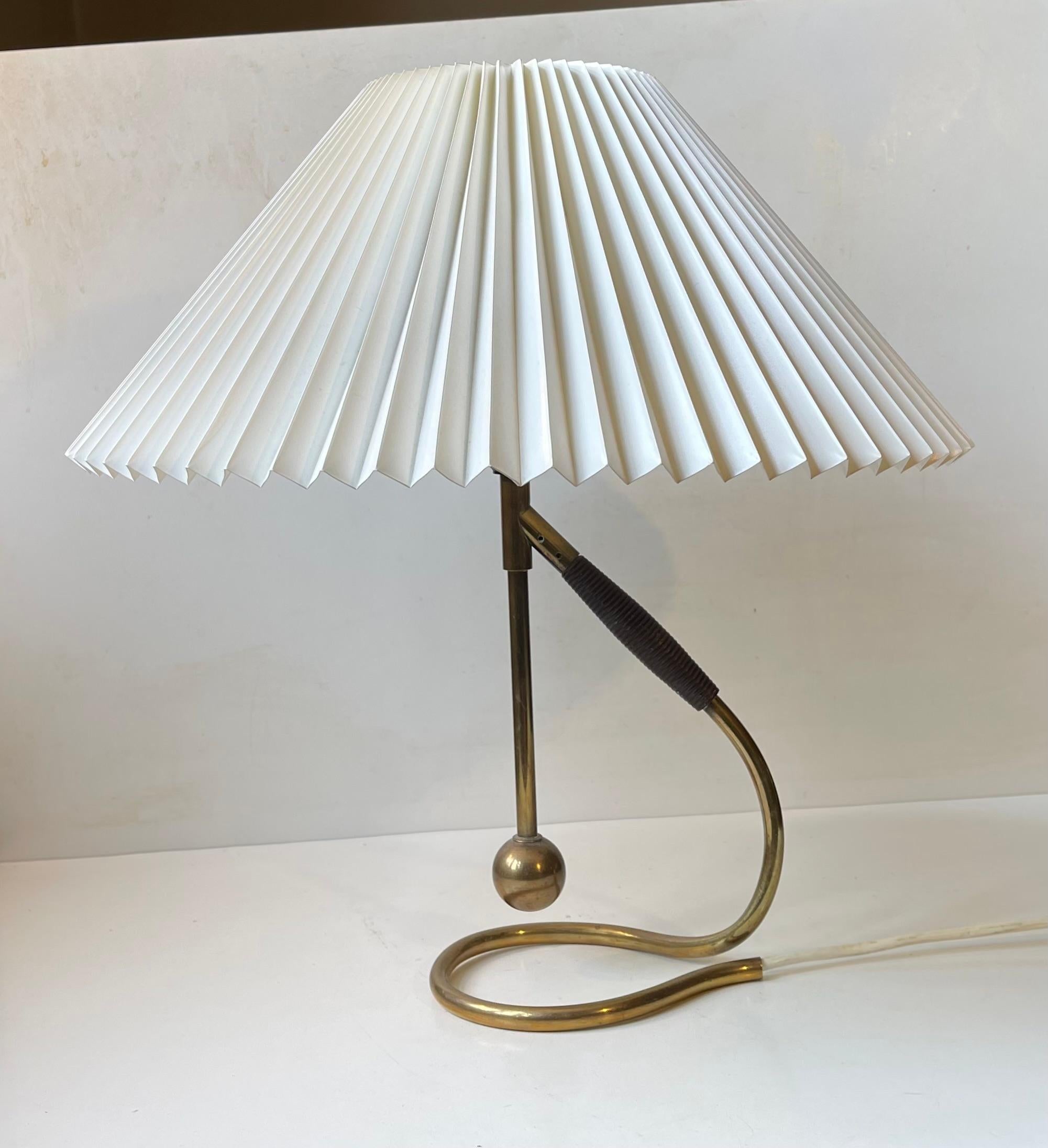 A very early model 306 hybrid wall or table lamp with base in solid tubular brass, bakelite socket and fluted Le Klint shade. Designed by architect and professor Kaare Klint in 1945. This example dates from the 1950s and has a model-correct more
