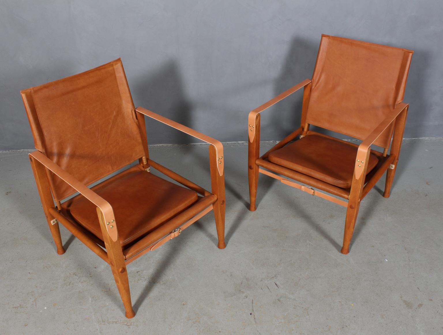 Kaare Klint for Rud Rasmussen. Pair of Safari chairs new upholstered with vintage aniline leather. New straps of butt hide leather.

Frame in solid ash.

Model Safari chair, made by Rud Rasmussen.