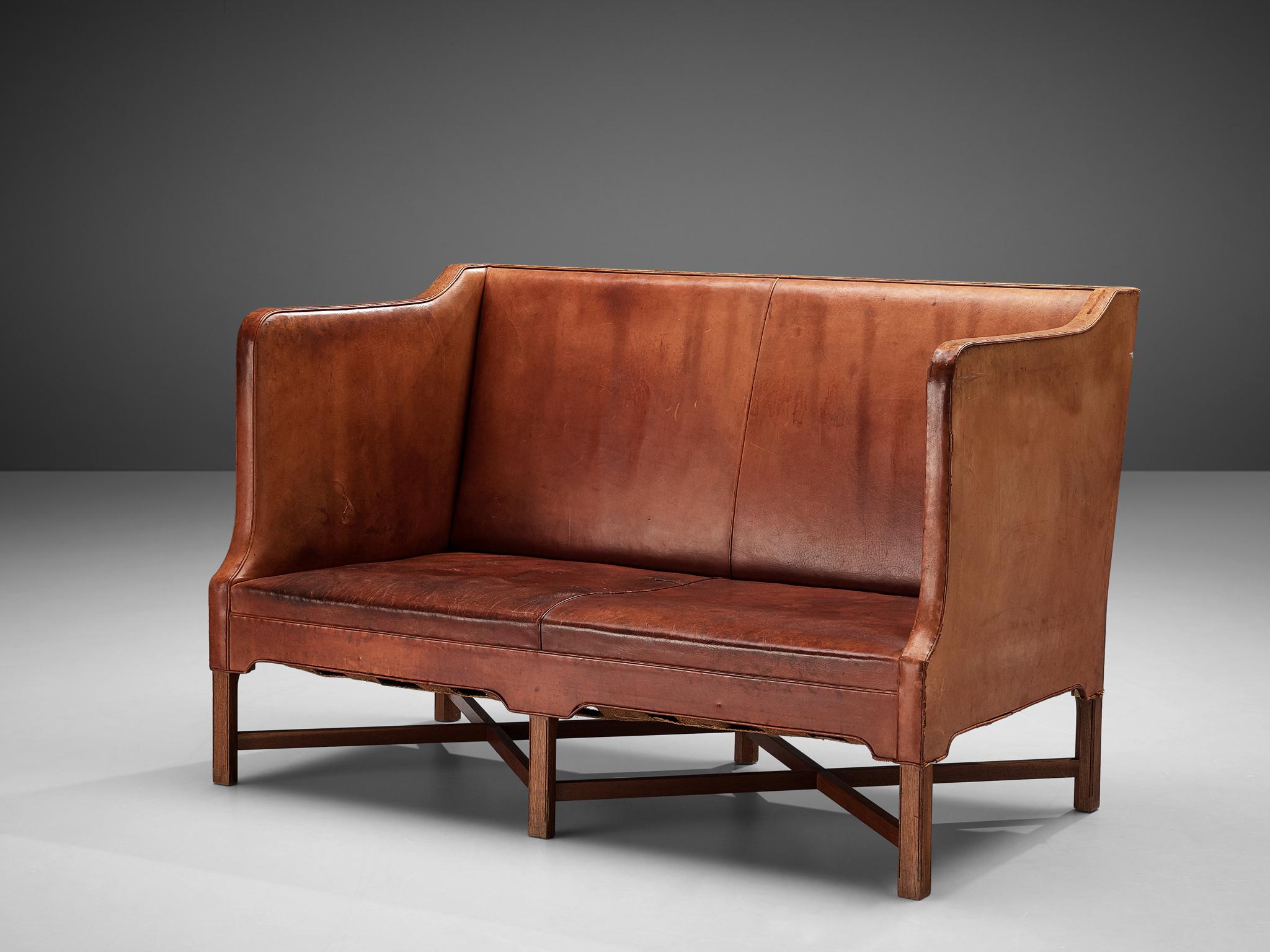 Kaare Klint for Rud Rasmussen, sofa 4118, original leather, mahogany, Denmark, 1930s

Classic and elegant Scandinavian two-seat sofa by Kaare Klint for manufacturer Rud Rasmussen. The piece is upholstered with patinated original leather. The base