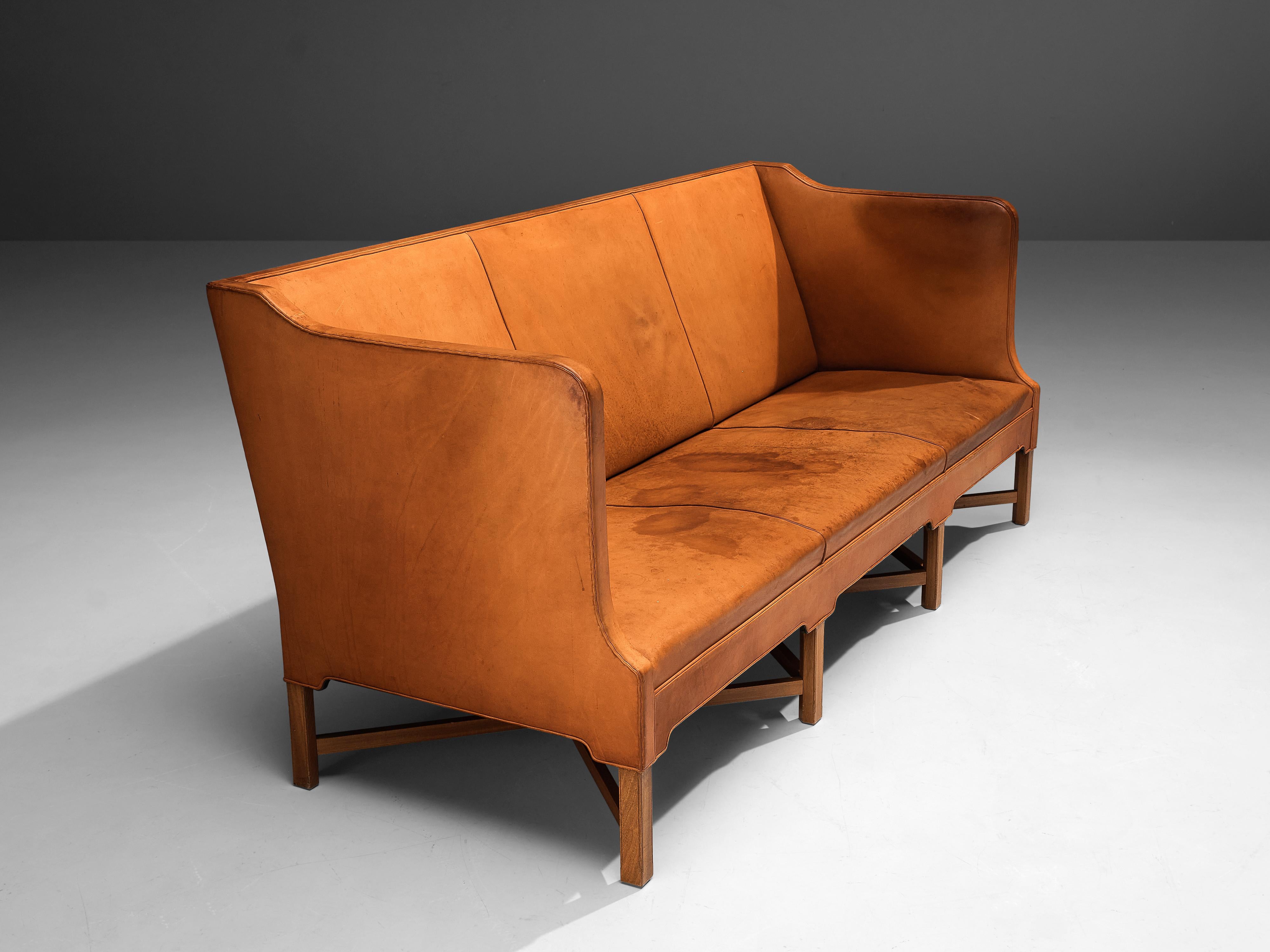 Kaare Klint for Rud Rasmussen, sofa model 4118, leather, mahogany, Denmark, design 1929

Classic and elegant Scandinavian three-seat sofa by Kaare Klint designed in 1929. The base consists of eight legs in mahogany with X-shaped cross-connections,