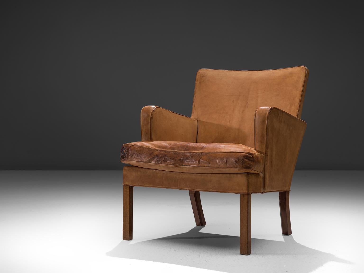 Kaare Klint for Rud. Rasmussen Snedkerier, easy chair model 5313, cognac leather and mahogany, Denmark, 1934.

This chair is the archetypical easy chair as it may, simple, solid and comfortable. As anything from Klint, this chair is anything but