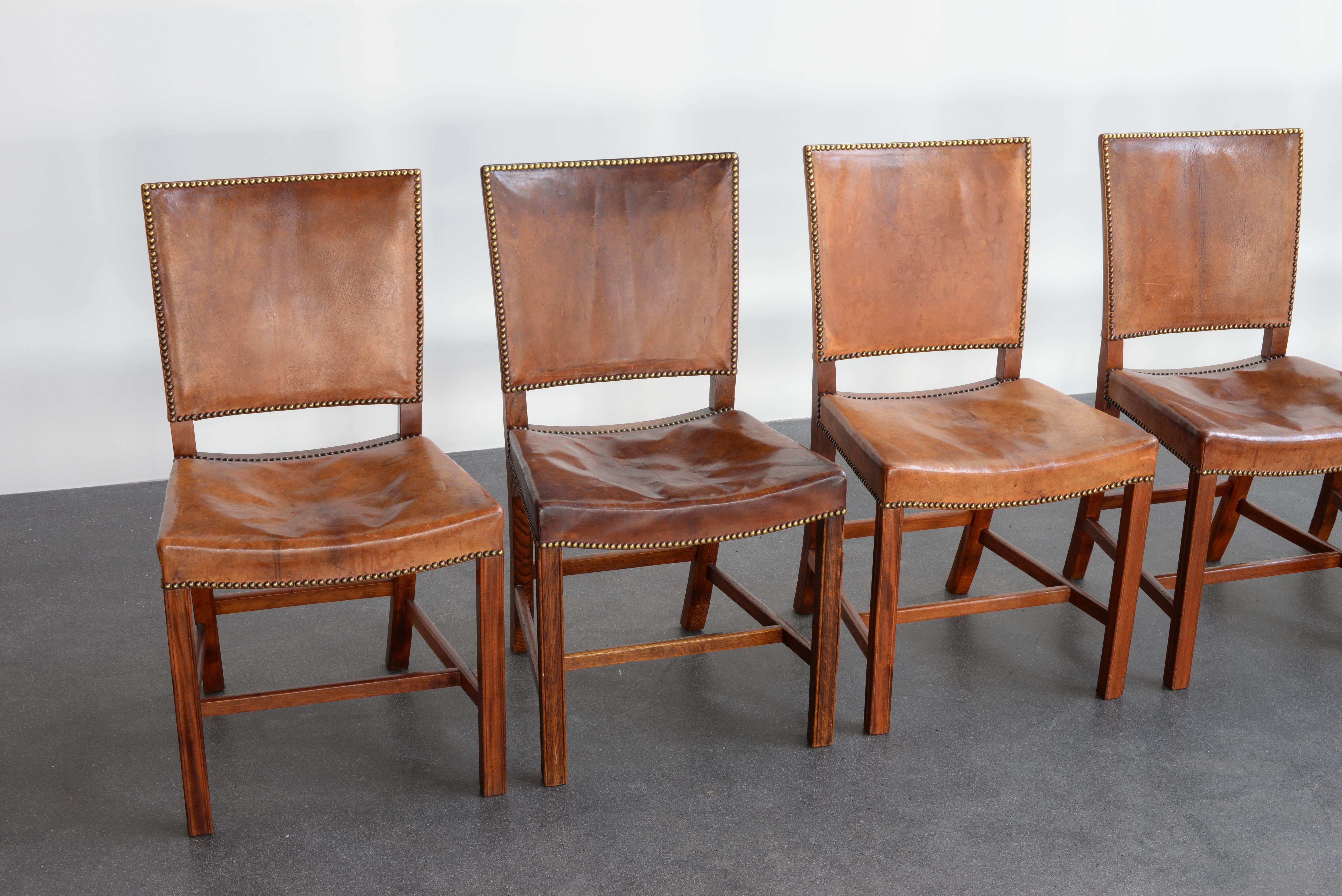 Kaare Klint set of nine red chairs. Executed by Rud. Rasmussen.

Mahogany, oak, Niger leather and brass.

Underside with manufacturer's paper label.