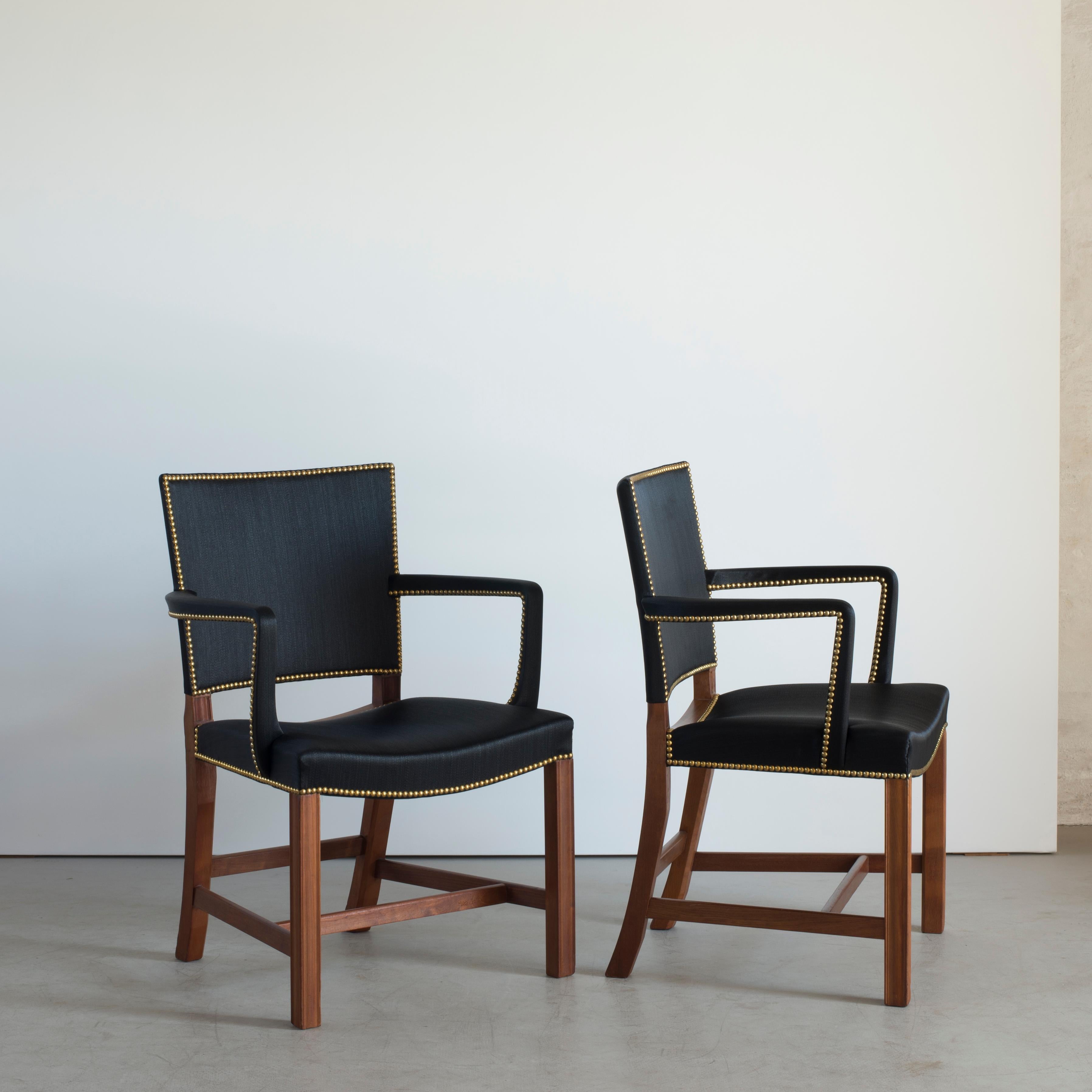 Kaare Klint pair of red chairs in mahogany, black horsehair and brass nails. Version of the chair with upholstered arms. Executed by Rud. Rasmussen, 1930s.

Underside with manufacturer's paper label RUD. RASMUSSENS/SNEDKERIER/45