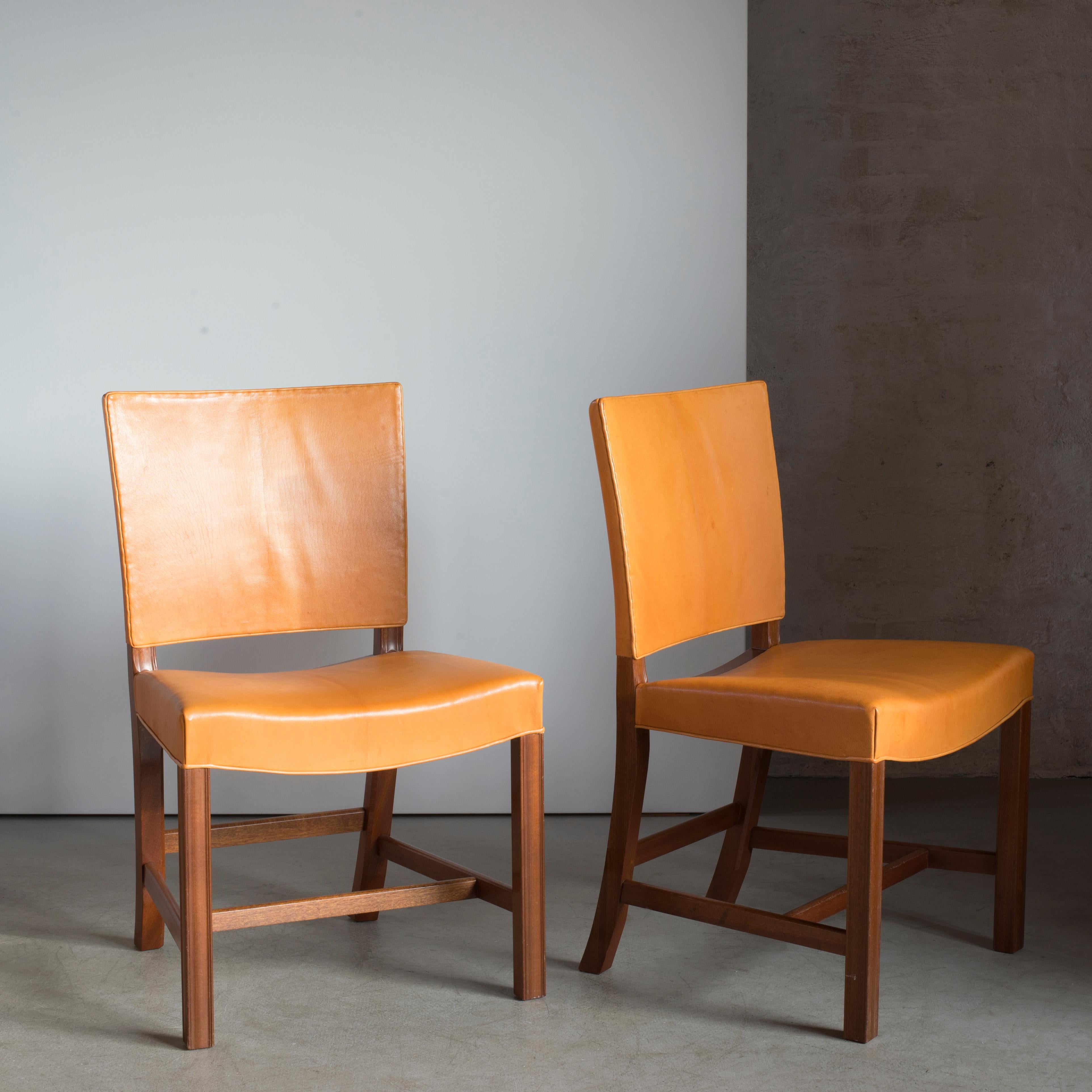 Kaare Klint pair of red chairs, mahogany, leather and brass. Executed by Rud. Rasmussen.