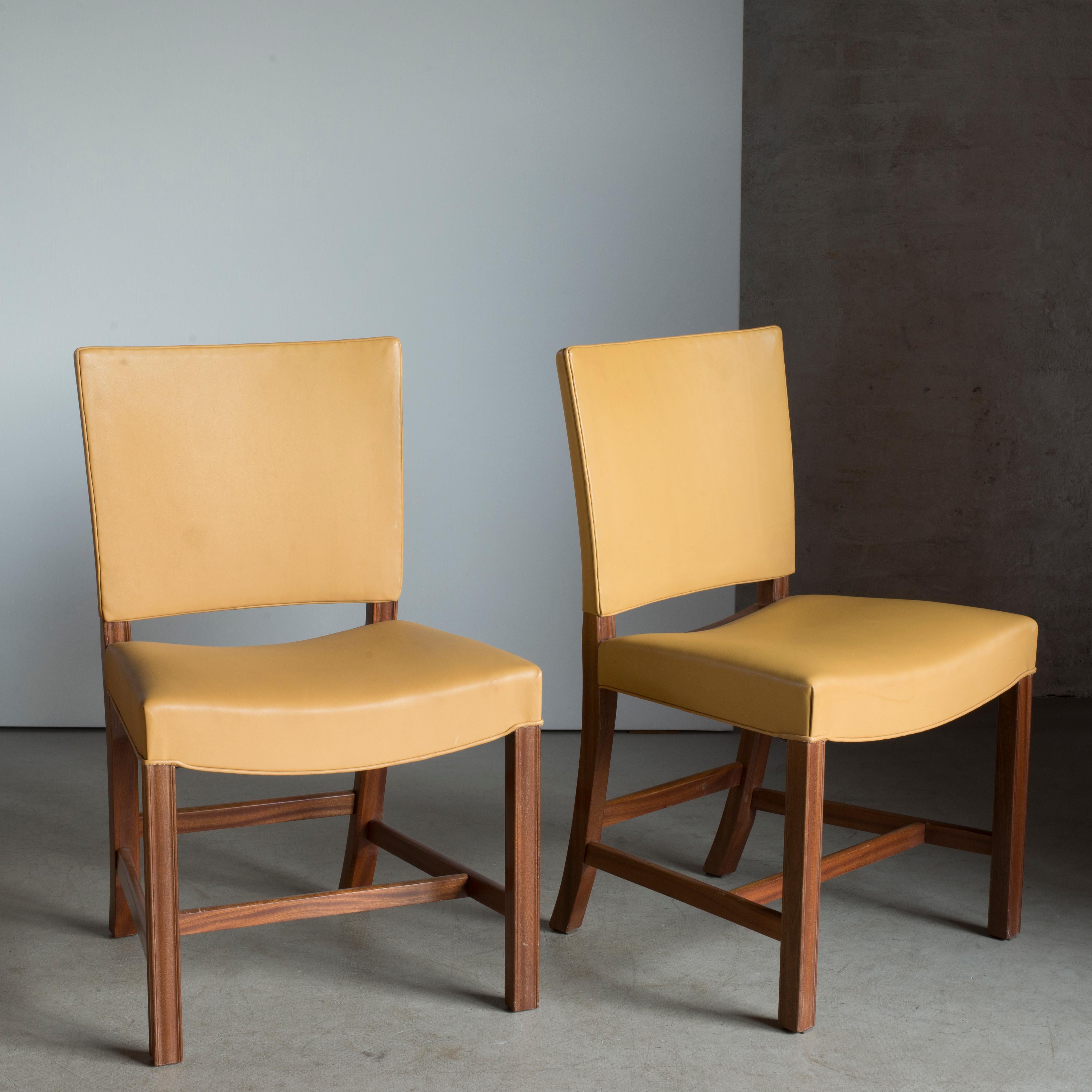 Kaare Klint pair of red chairs, mahogany and leather. Executed by Rud. Rasmussen.