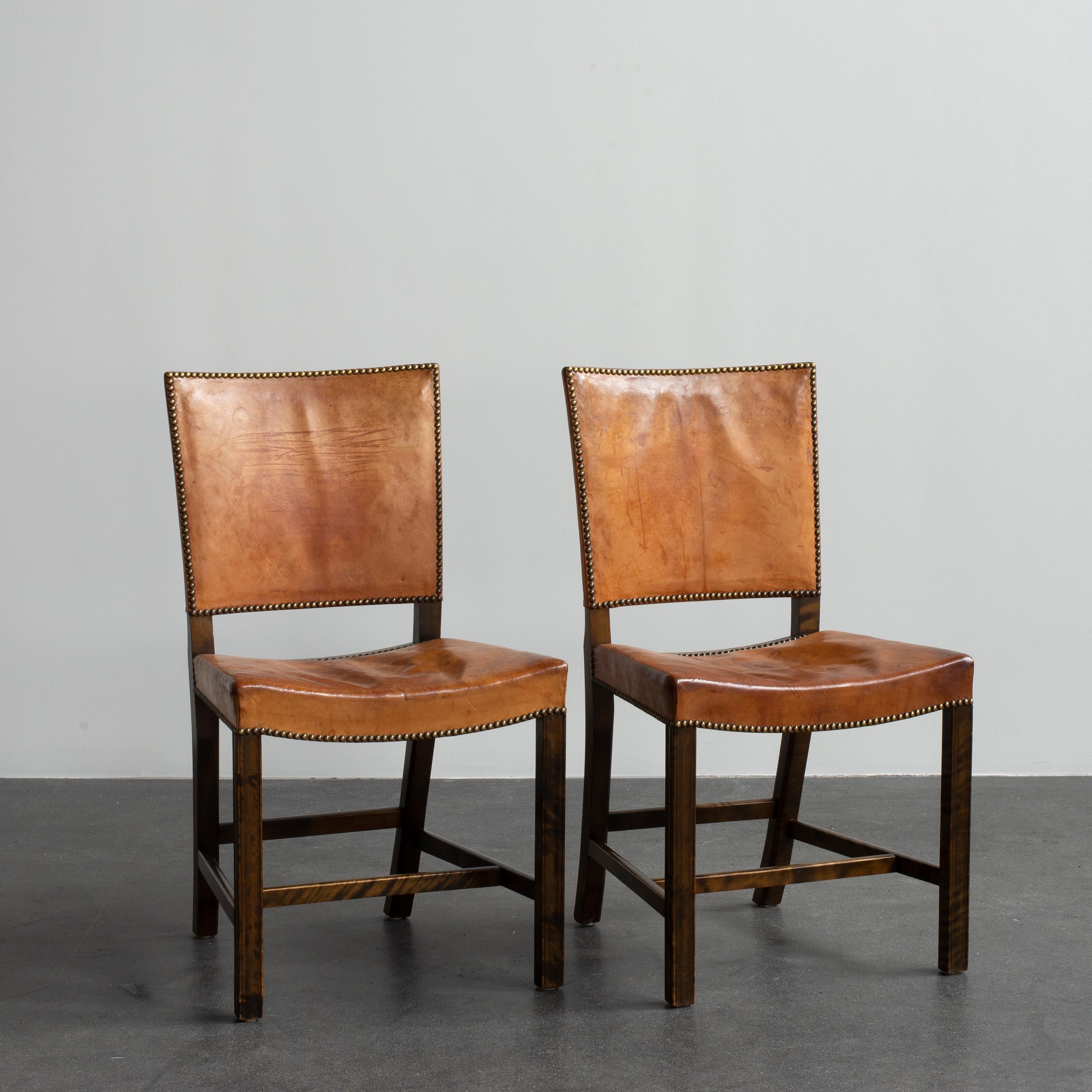 Kaare Klint pair of Red Chairs. Executed by Rud. Rasmussen.

Stained Birch, Niger leather and Brass

Underside with manufacturer's paper label RUD. RASMUSSENS/SNEDKERIER/45 NØRREBROGAD/KØBENHAVN, penciled number and architect's monogrammed paper