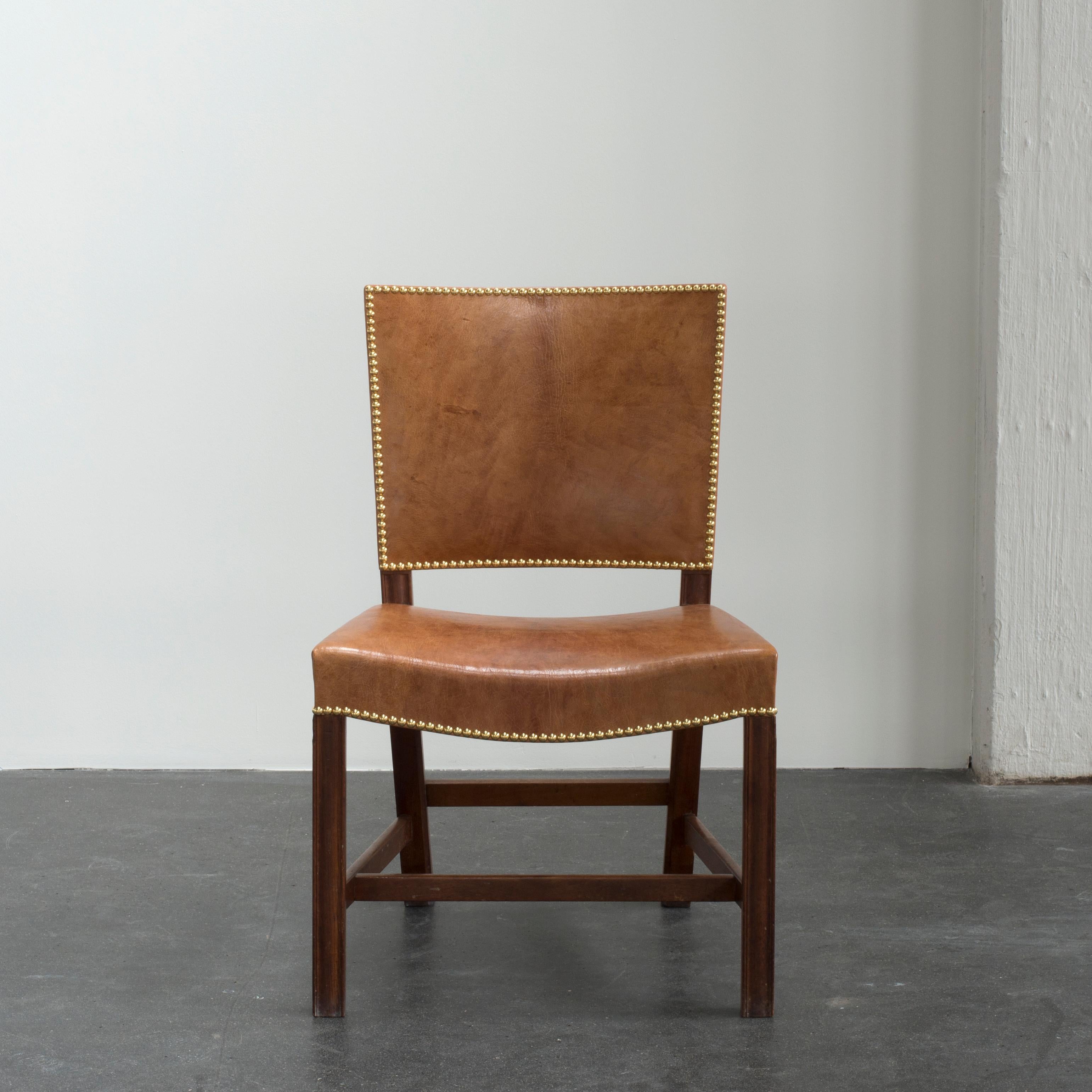 Kaare Klint 'Red Chair' in Cuban mahogany, Niger leather and brass nails. Executed by Rud. Rasmussen.

Underside with manufacturer's paper label RUD. RASMUSSENS/SNEDKERIER/45 NØRREBROGAD/KØBENHAVN and architect's monogrammed paper label.