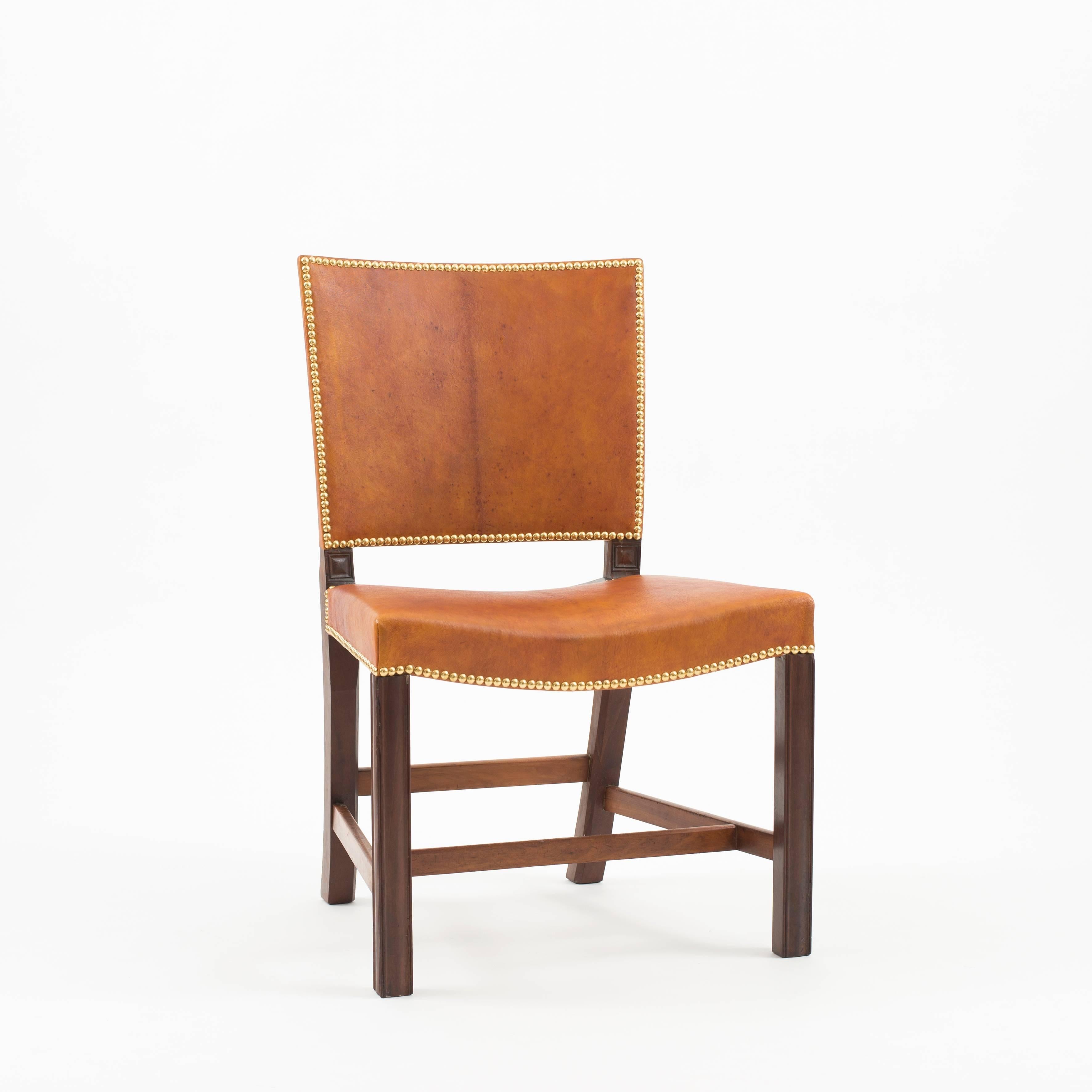Kaare Klint red chair in Cuban mahogany, Nigerian leather and brass nails. Executed for the Danish Chamber of Commerce by C. B. Hansen in 1928.

Four chairs available.
