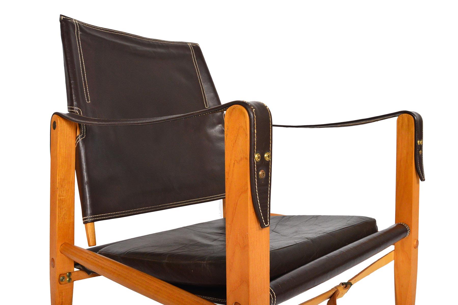 This gorgeous Danish modern safari chair was designed by Kaare Klint for Rud Rasmussen in the 1933. The exposed oak frame uses the support of doweled rods, slung leather, and brass buckled straps. The backrest swivels for added comfort. The