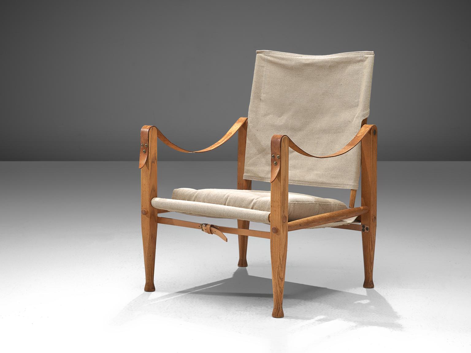 Kaare Klint for Rud Rasmussen, Safari chair with cushion, ash wood, leather and undyed linen, Denmark, design 1933.

Stunning safari lounge chair designed by Kaare Klint for Rud Rasmussen. Covered with its original upholstery, this specific model