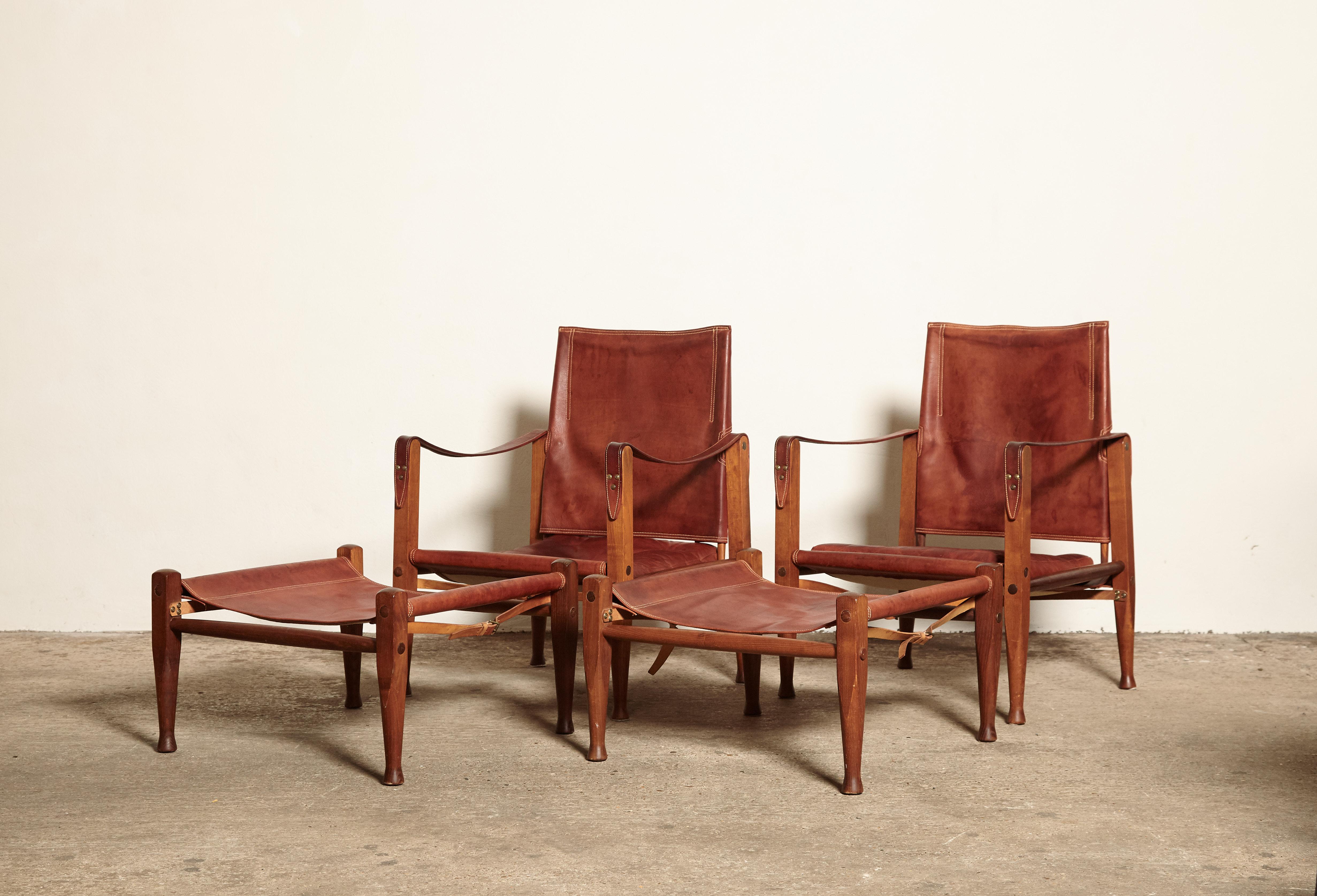 A rare and stunning pair of safari chairs and matching foot stools designed by Kaare Klint. Ashwood frame and beautifully patinated original leather. Designed in 1933 by Kaare Klint for Rud. Rasmussen, Copenhagen, Denmark. Good vintage condition