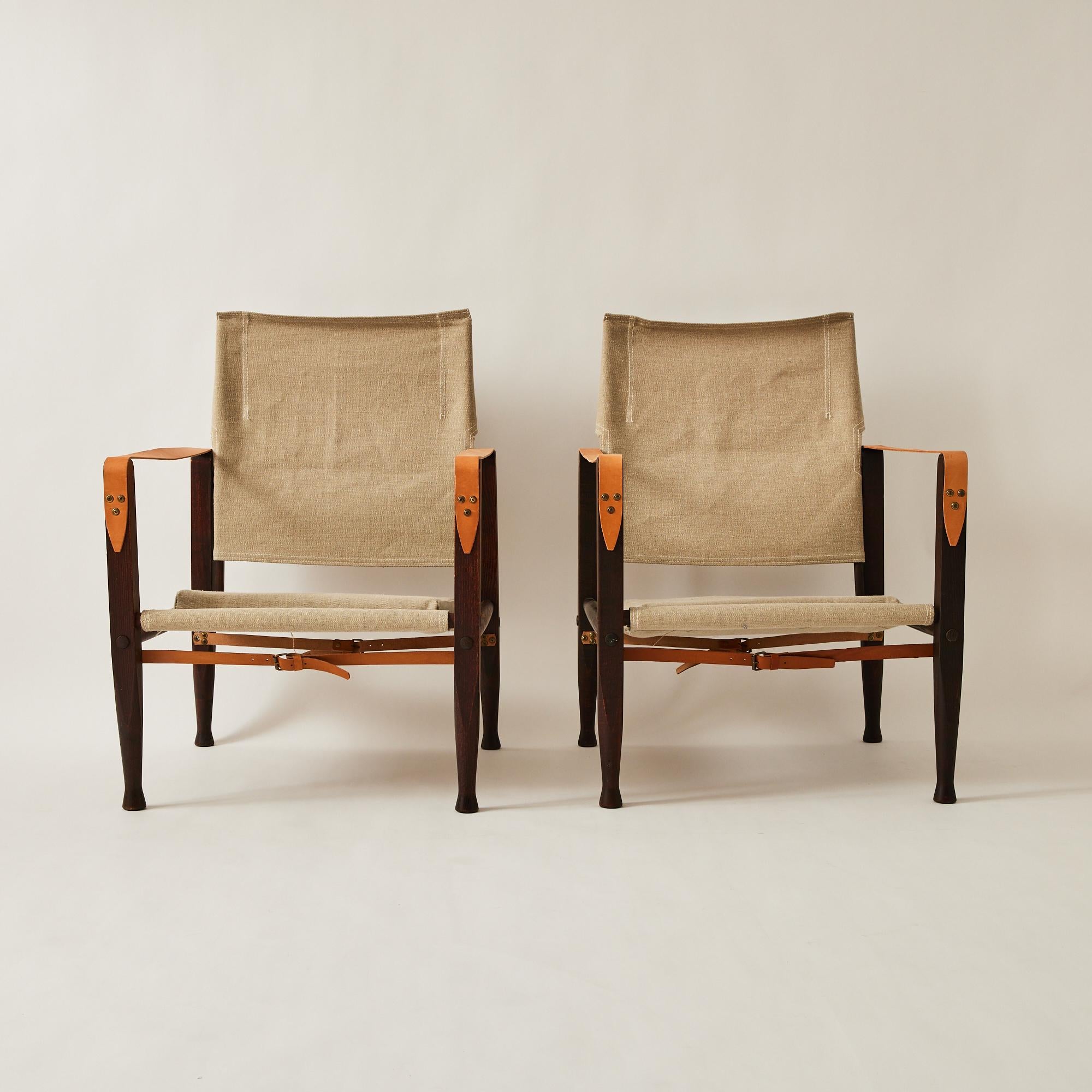 These Safari chairs were designed by Danish designer Kaare Klint who is known as the father of Danish modernism. They were designed in the 1930s and manufactured by Rud Rasmussen in the 1960's. Klint was inspired by images of the Roorkhee chair